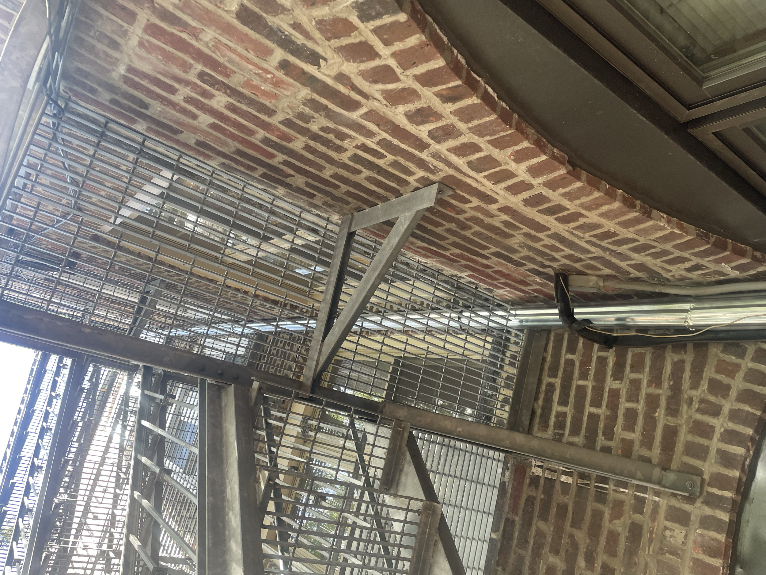 Exterior view of a metal fire escape attached to a brick building