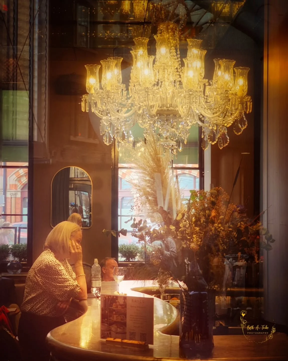 &ldquo;Where Light Meets Silence&rdquo;

Waiting for the train to arrive,  I walked around the gorgeous King's Cross train station.  Came across this woman at the GNH Bar &amp; Terrace.

#uktrip
#cellphonephotography 
#London
#kingscrossstation
#soli
