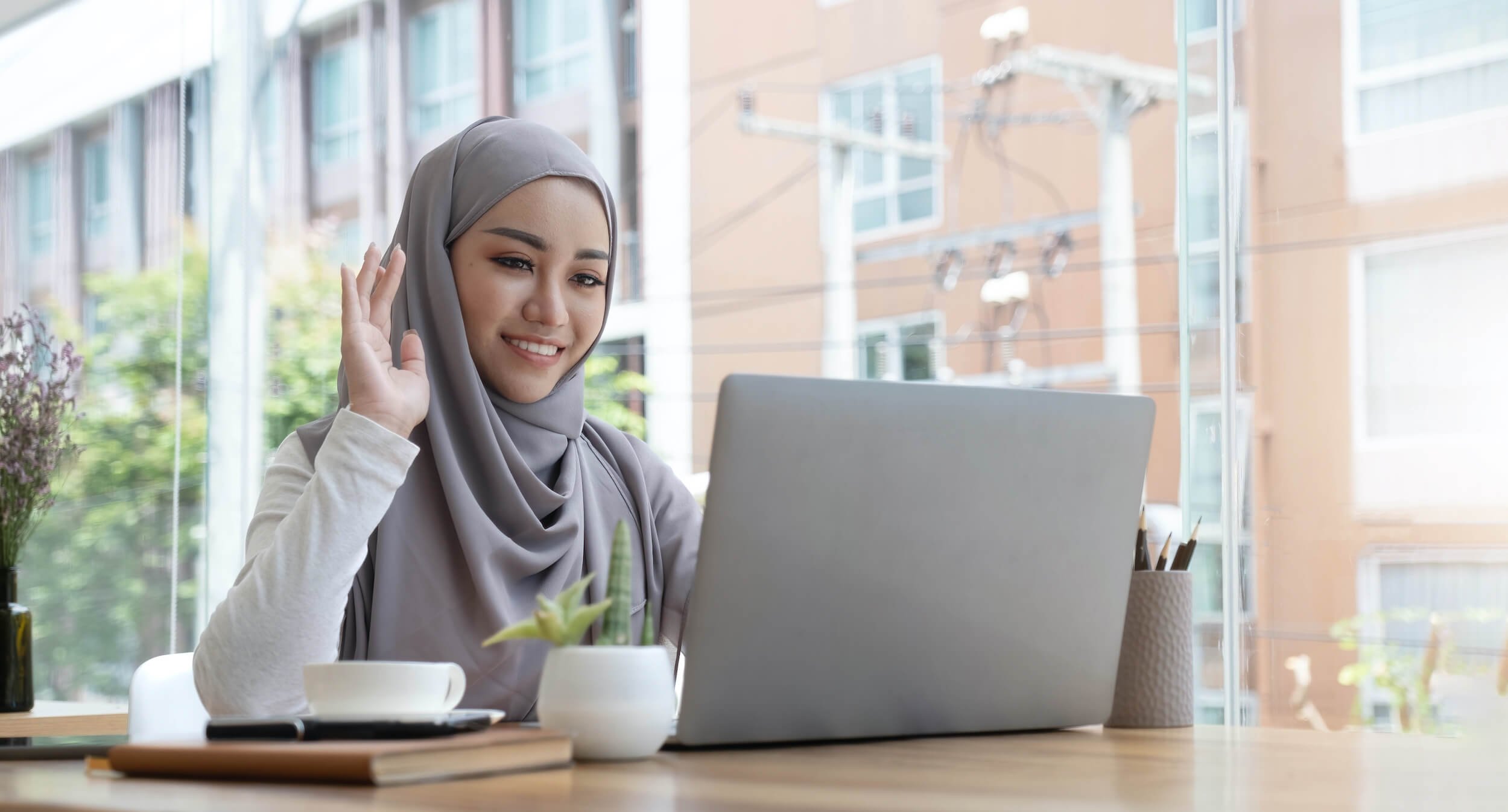 lovely young Arab woman waving on video call