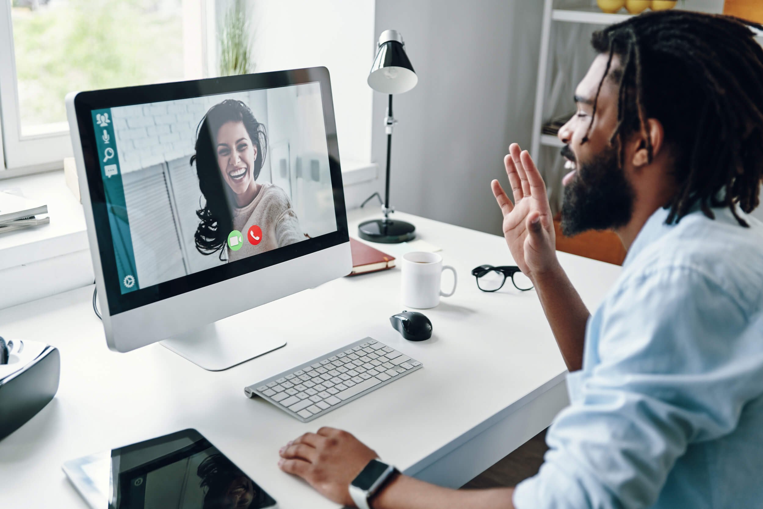 Young man and smiling woman on video chat