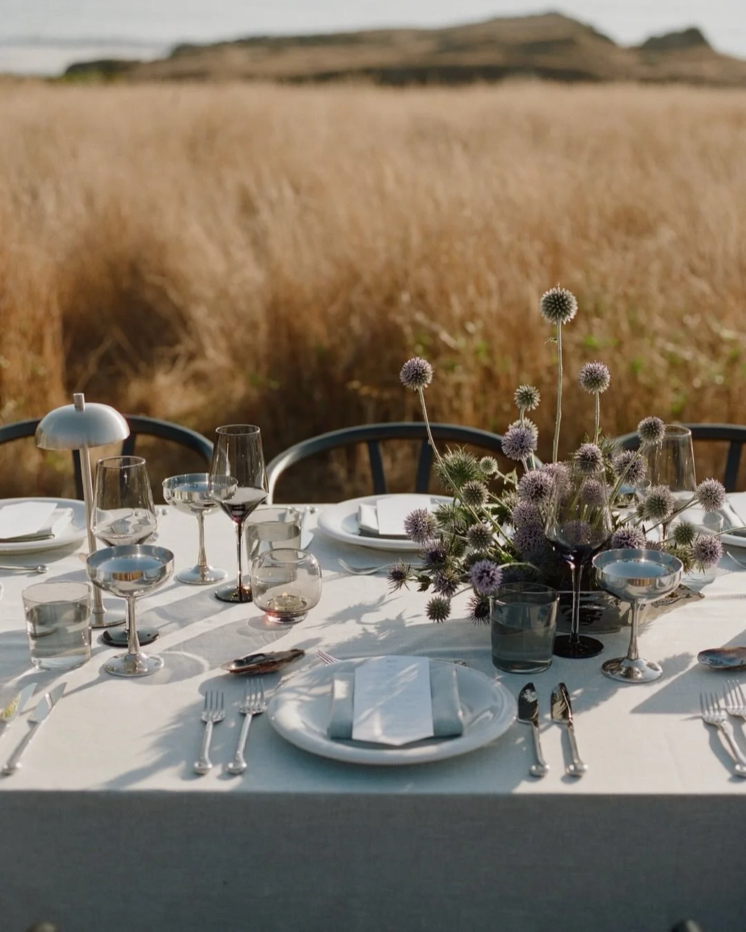 A tablescape inspired by oceanic details and a love of blue. 🌊 
Soft gradients of blue set the tone, layered with eclectic florals and hints of chrome that catch the light just right! 
At each place, hand-painted mussel shells collected by Olivia + 