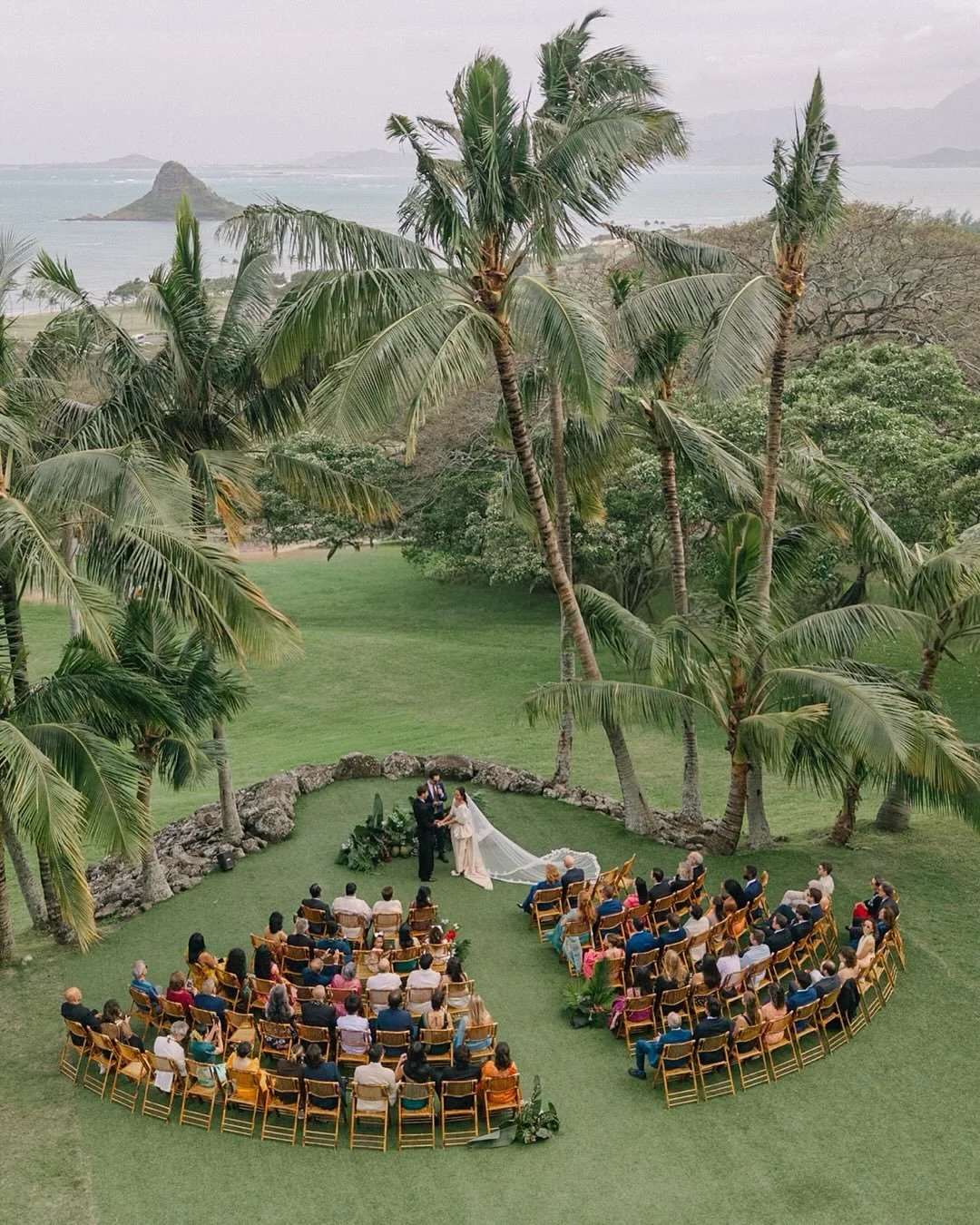 Set beneath the sacred Kanehoalani peak at Kualoa Ranch, Ashley &amp; Evan&rsquo;s wedding unfolded against the breathtaking beauty of Oʻahu, a setting that felt grounded, romantic, and unforgettable. 
Inspired by the landscape surrounding them, the 