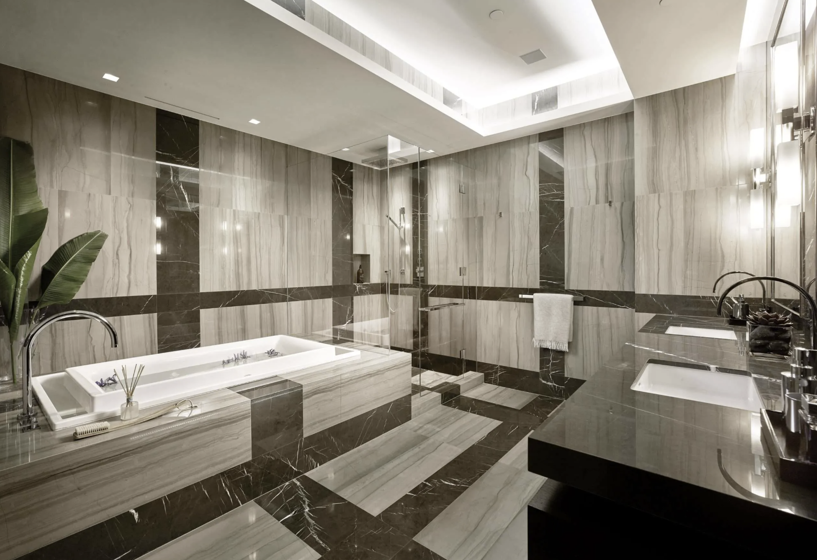 Luxurious modern marble bathroom with bathtub, shower, and dual sinks.