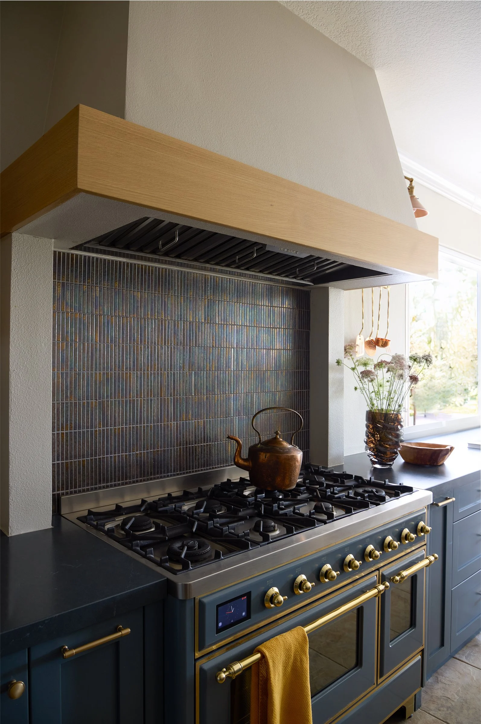 custom rustic Italian contemporary kitchen ilve majestic range with oak wood dark blue cabinetry brass and copper accents