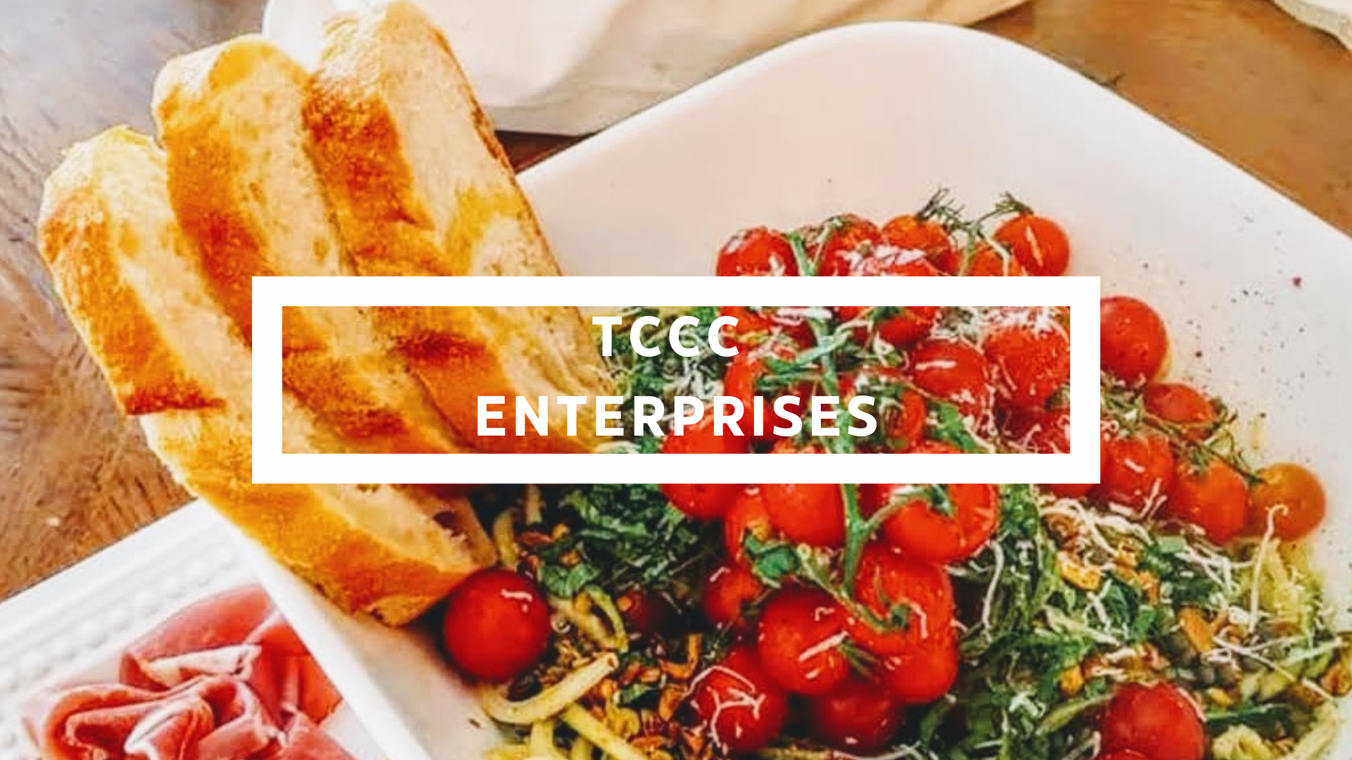 A plate with toasted bread slices and a cherry tomato salad garnished with cheese and herbs, on a wooden table.