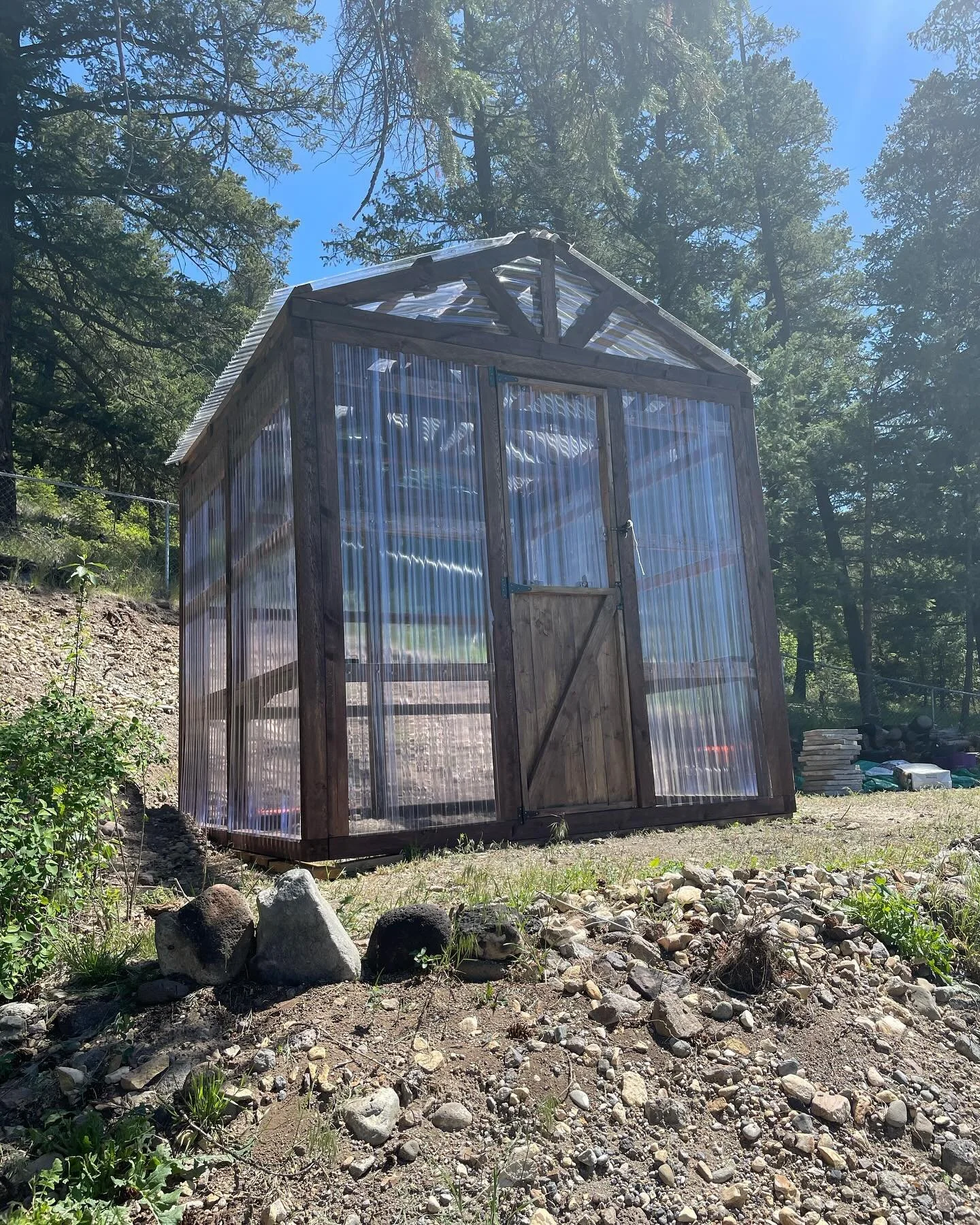 Beautiful 10 by 10 post &amp; beam greenhouse completed today! Complete with shelves &amp; timber trusses to hang baskets from, with a beautiful view of Williams lake in the distance