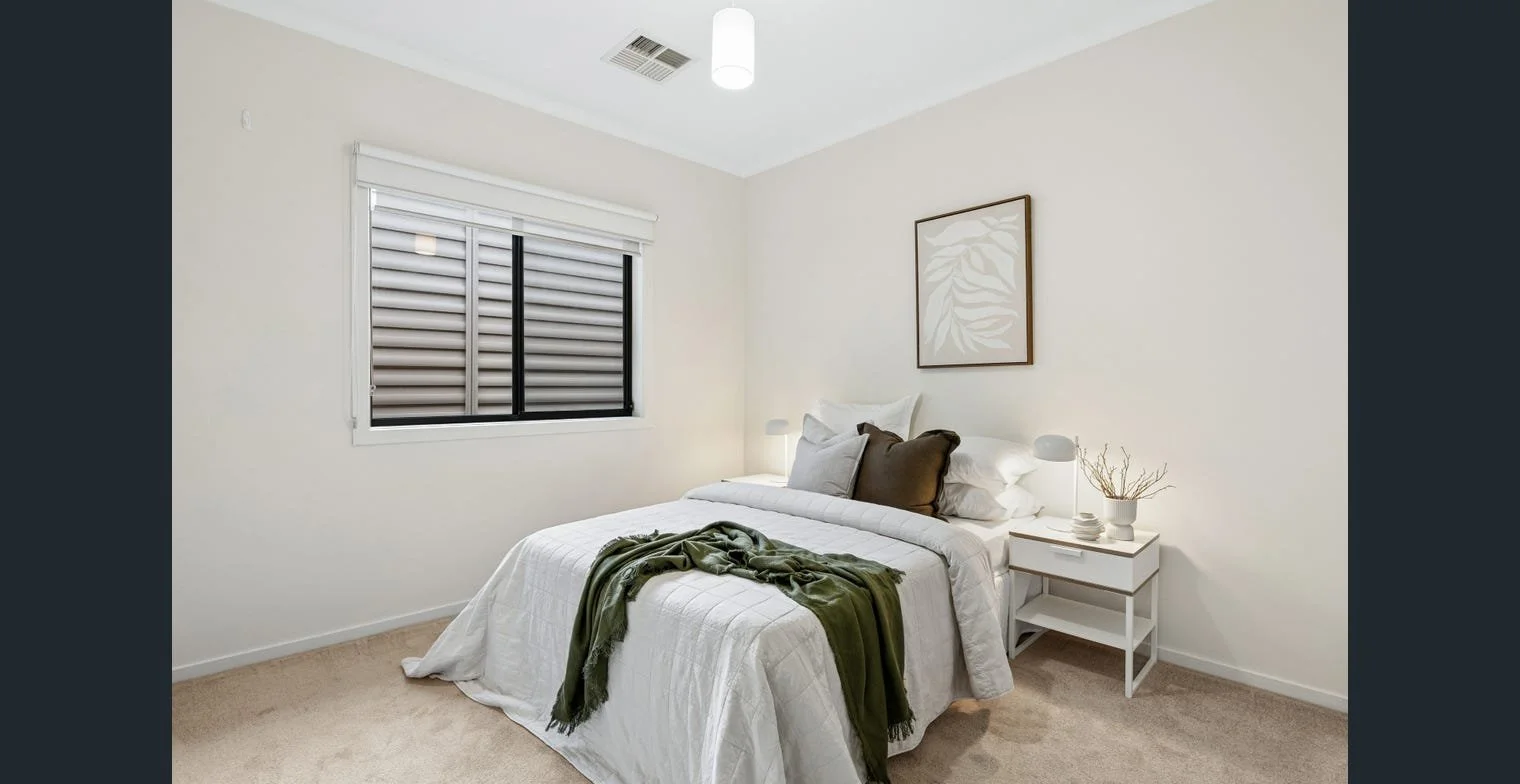 Bedroom in a styled rental home, with indoor-outdoor flow and neutral furnishings. Strategic property management by Serenity Homes & Design