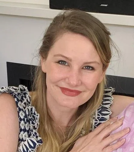 Isabella Valette smiling in floral-patterned dress indoors, close-up view