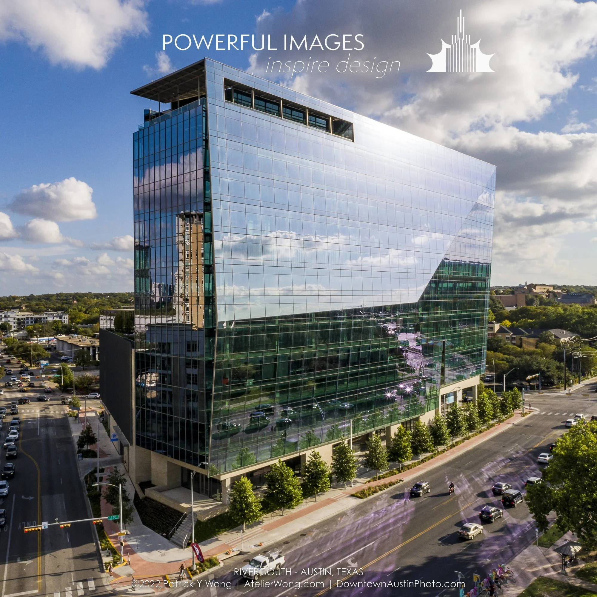 A modern glass office building reflecting the blue sky, clouds, and surrounding cityscape, located in Austin, Texas.
