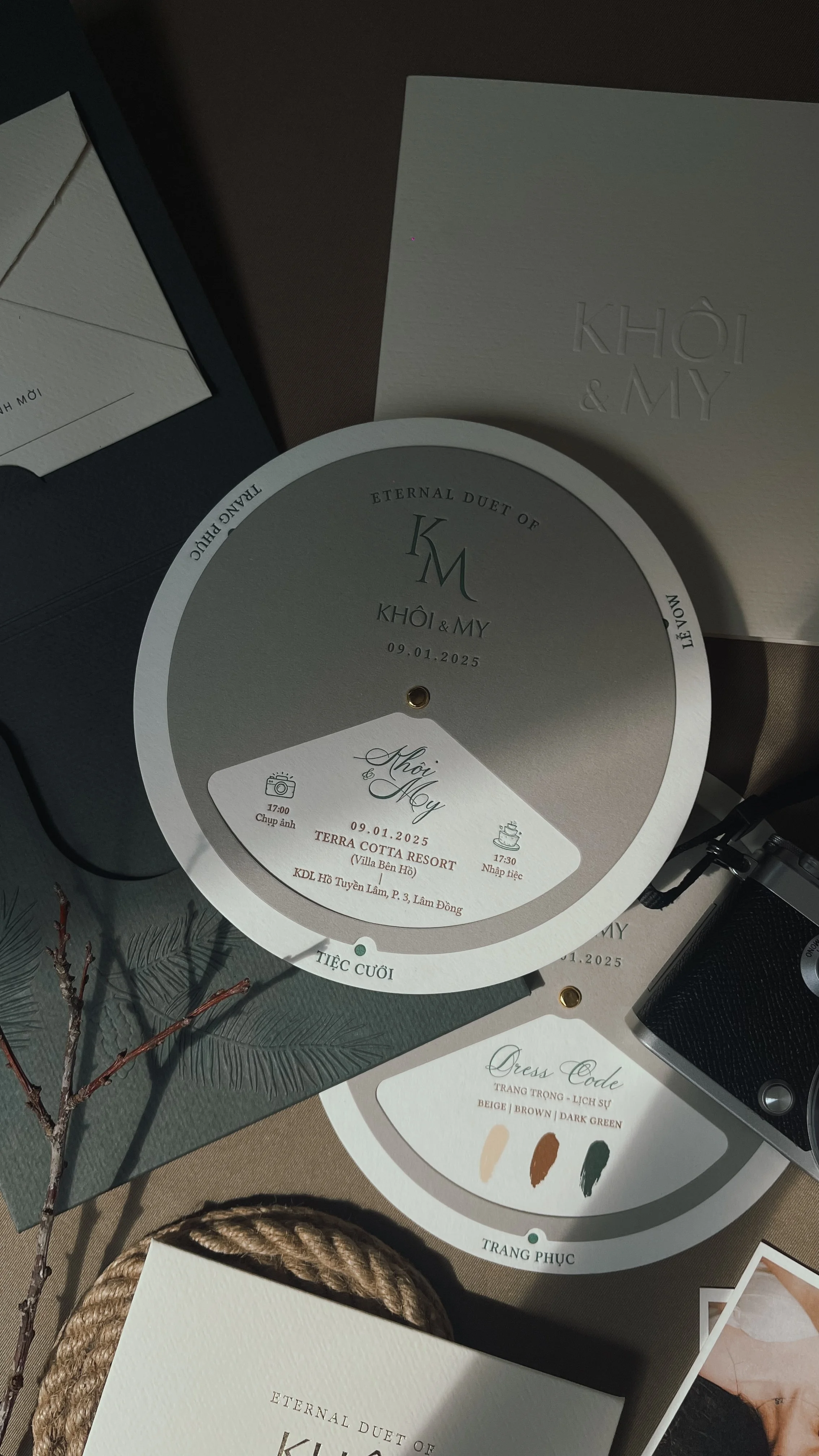 A wedding invitation board with details for the wedding of Khôi and My on January 9, 2025, at Terra Cotta Resort, including schedule and dress code information.