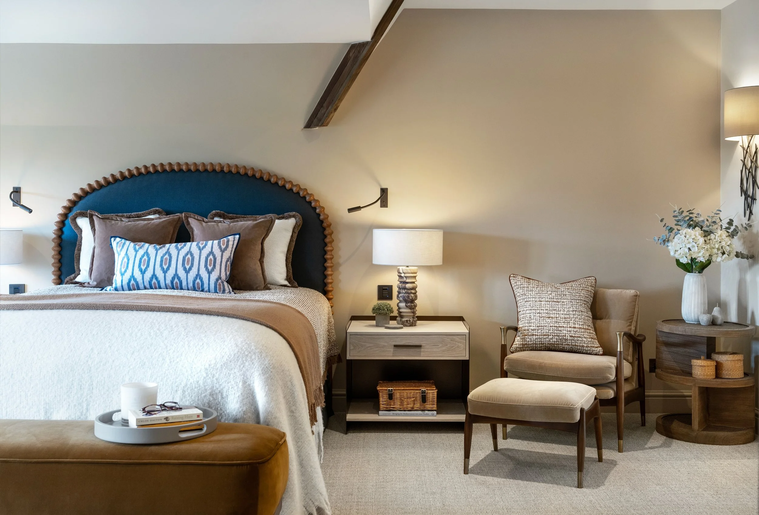 FARMHOUSE BEDROOM DESIGN

A closer look at the primary bedroom at our Meadowcroft project. We approached the space structurally, creating a new dressing zone, then layered lighting and textures to create a calm, hotel-like feel, complete with a built