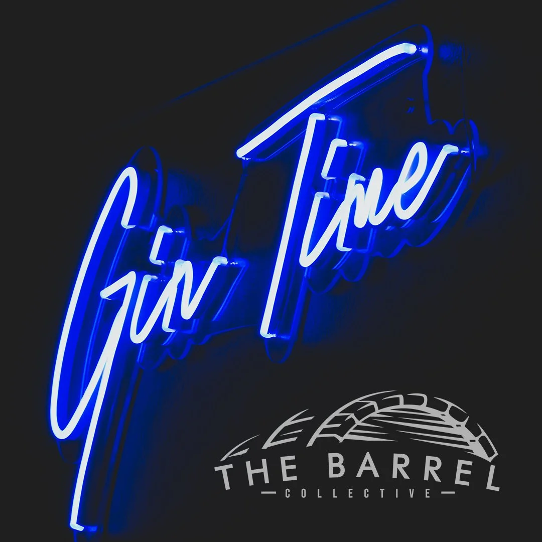Neon sign that says "Fue Tuno" in blue with a logo below that reads "The Barrel Collective" featuring a stylized barrel and lid.