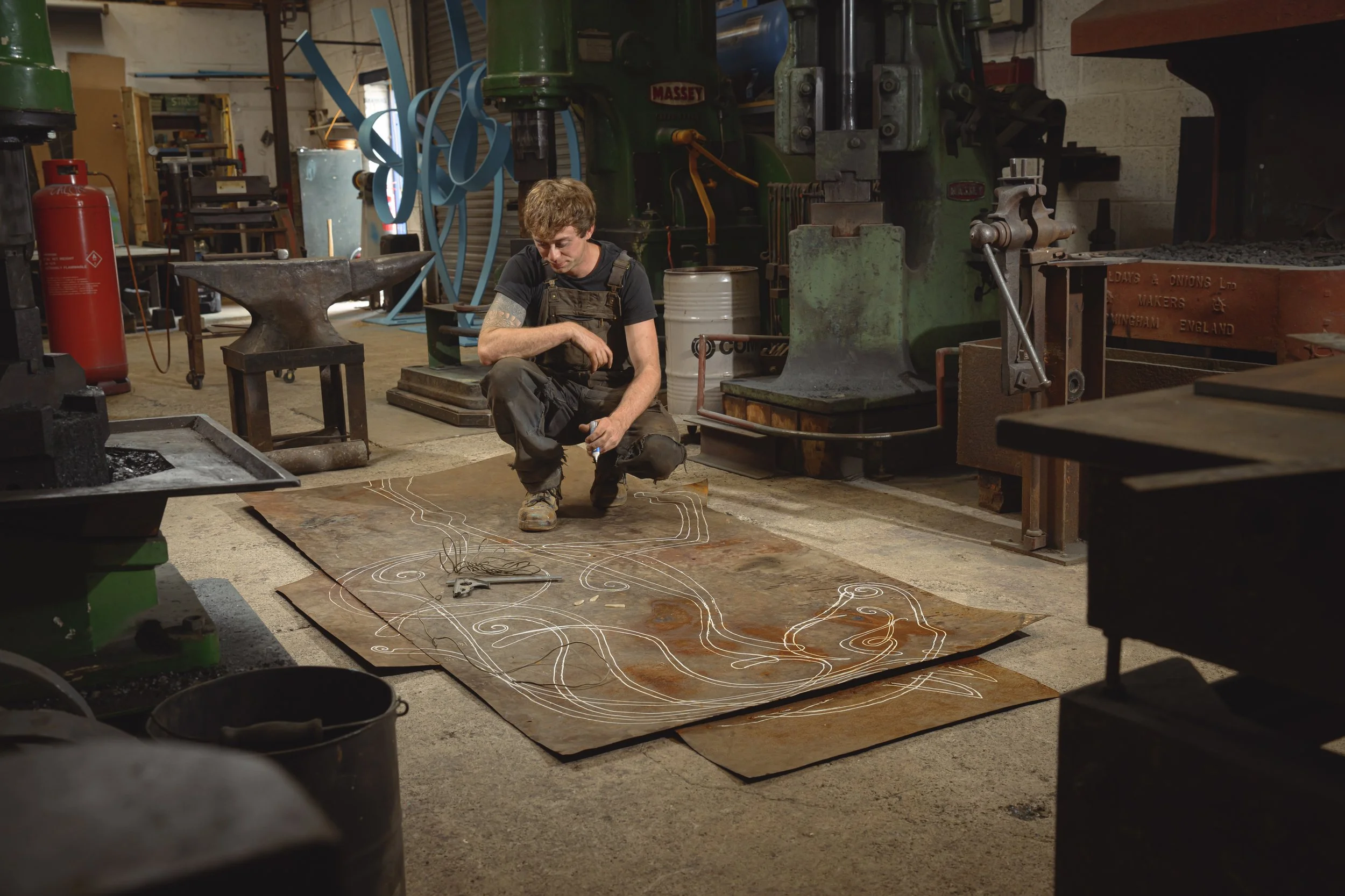 drawing a design in full scale on the floor for a large horse sculpture