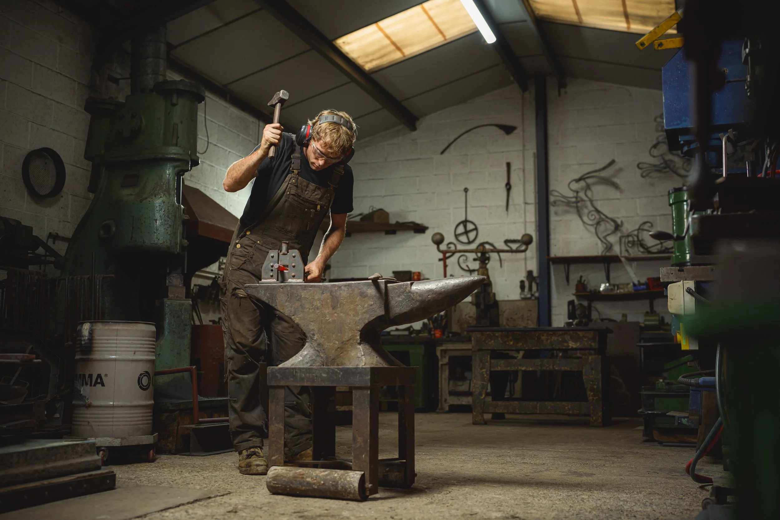 hammering metal on the anvil in the blacksmiths forge - kit garnett