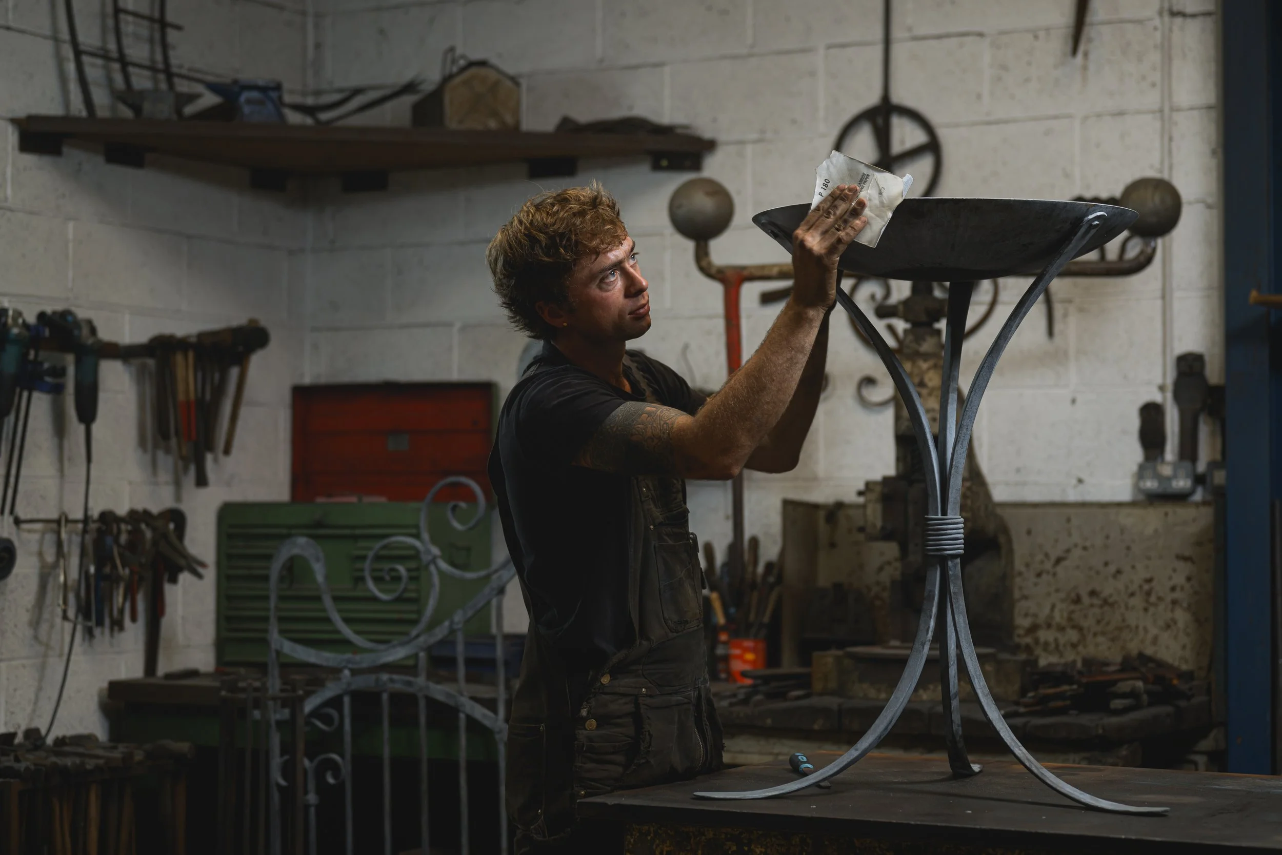 kit garnett finishing off a bird bath, sanding any rough edges