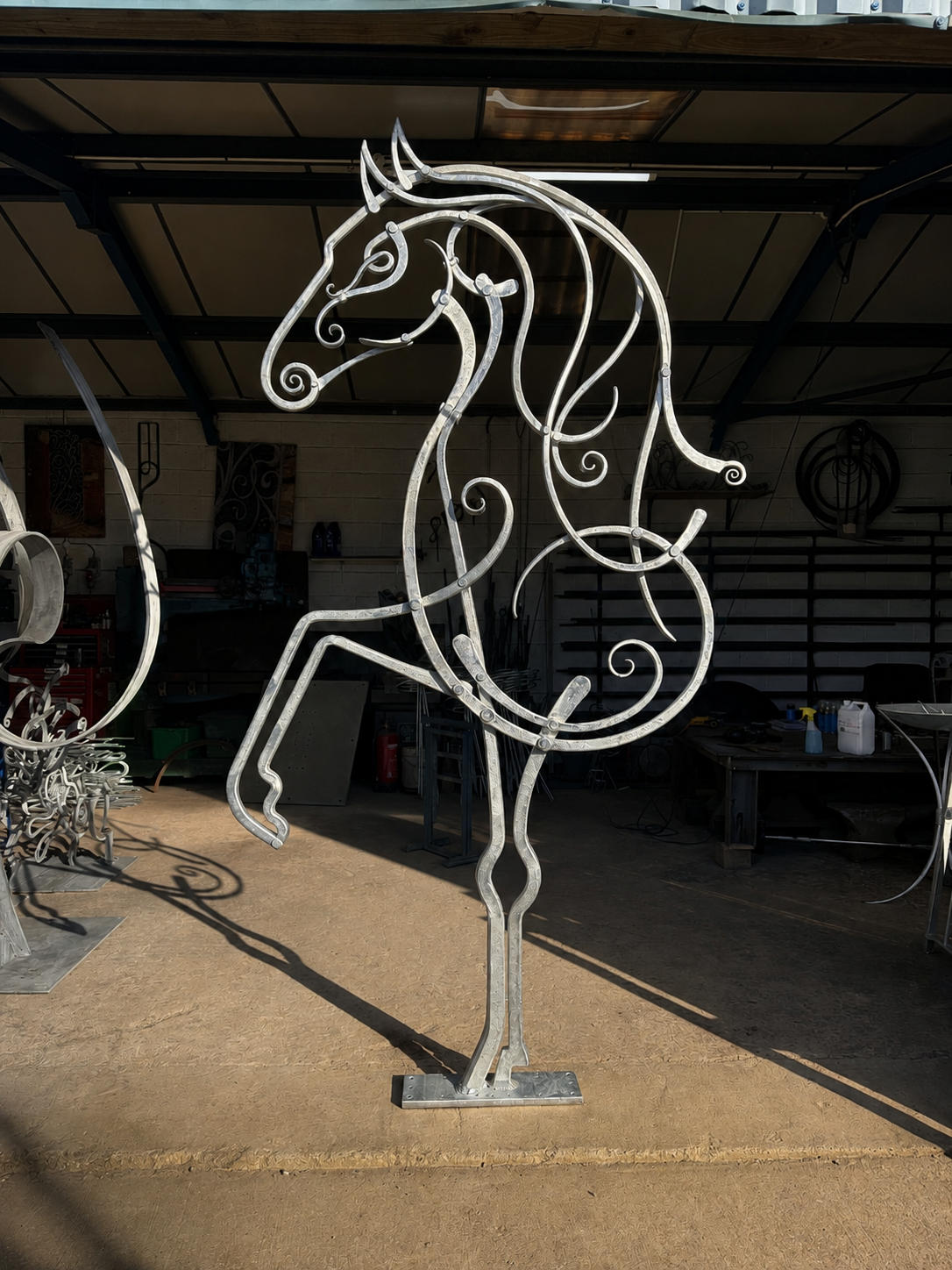 large steel horse sculpture - between steps - made by artist kit garnett