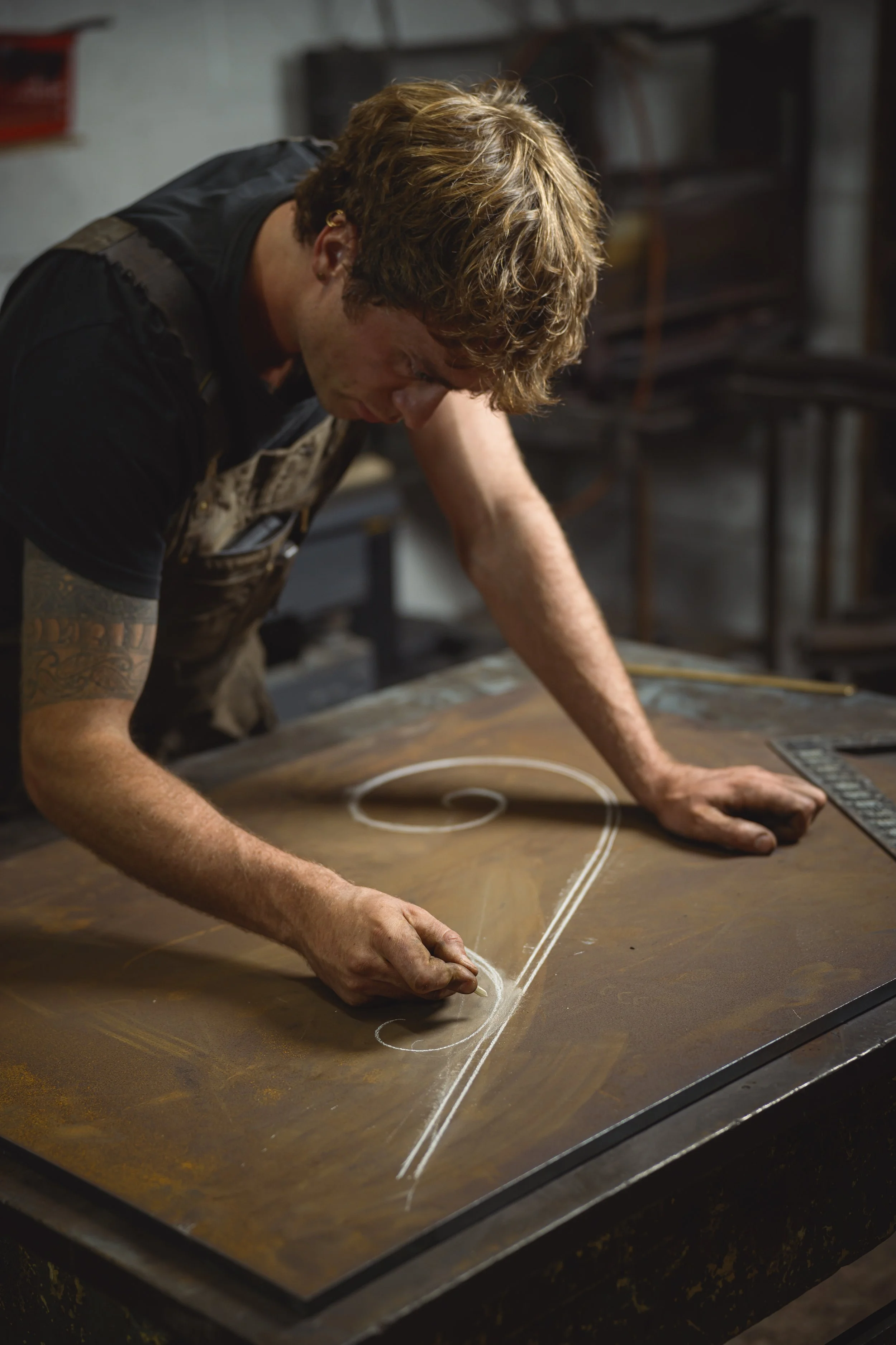 kit garnett drawing with chalk a handrail design for an upcoming commision in the forge