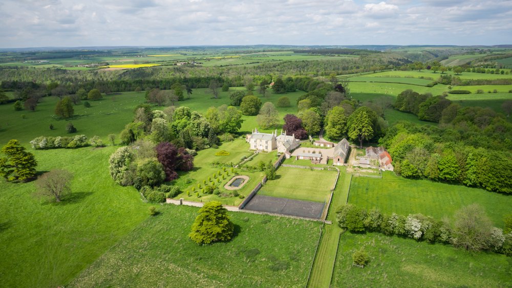  aerial drone image of country estate with walled garden surrounded by countryside  