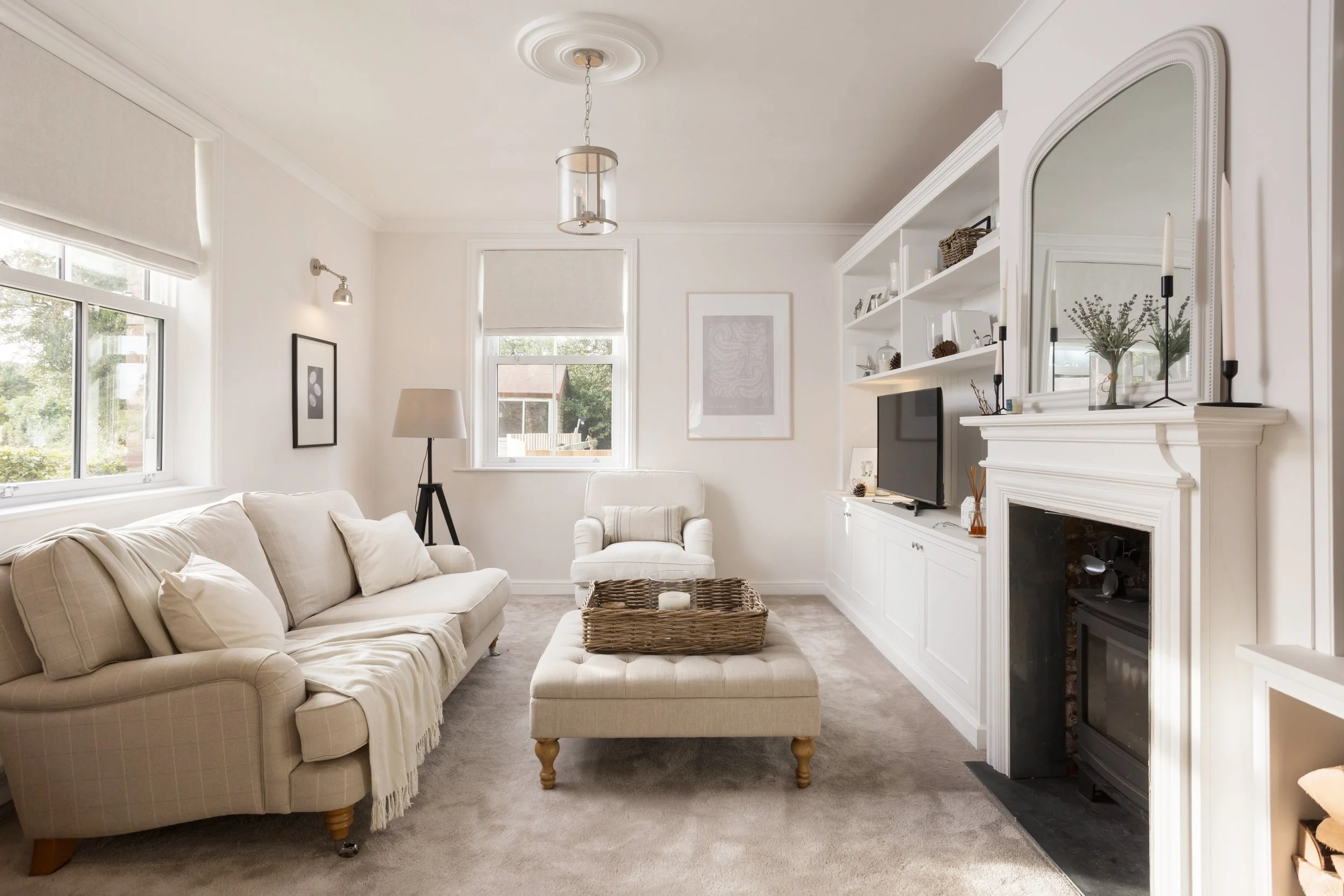 crisp white living room in a freshly decorated cottage living room with log burner
