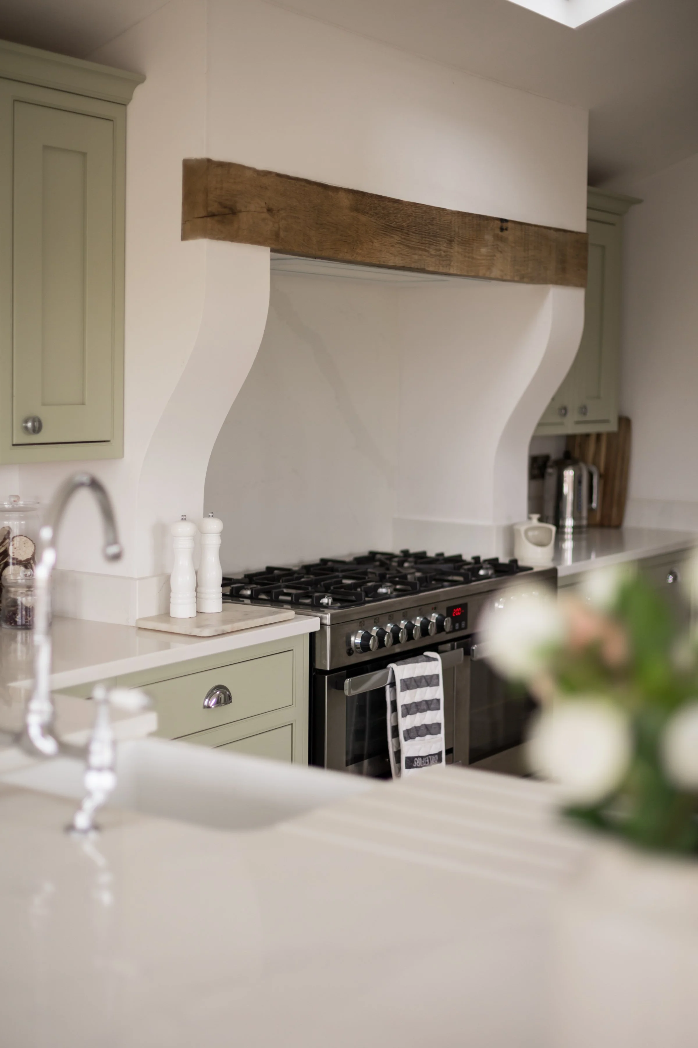 detail of kitchen stove set into chimney breast with wooden lintel