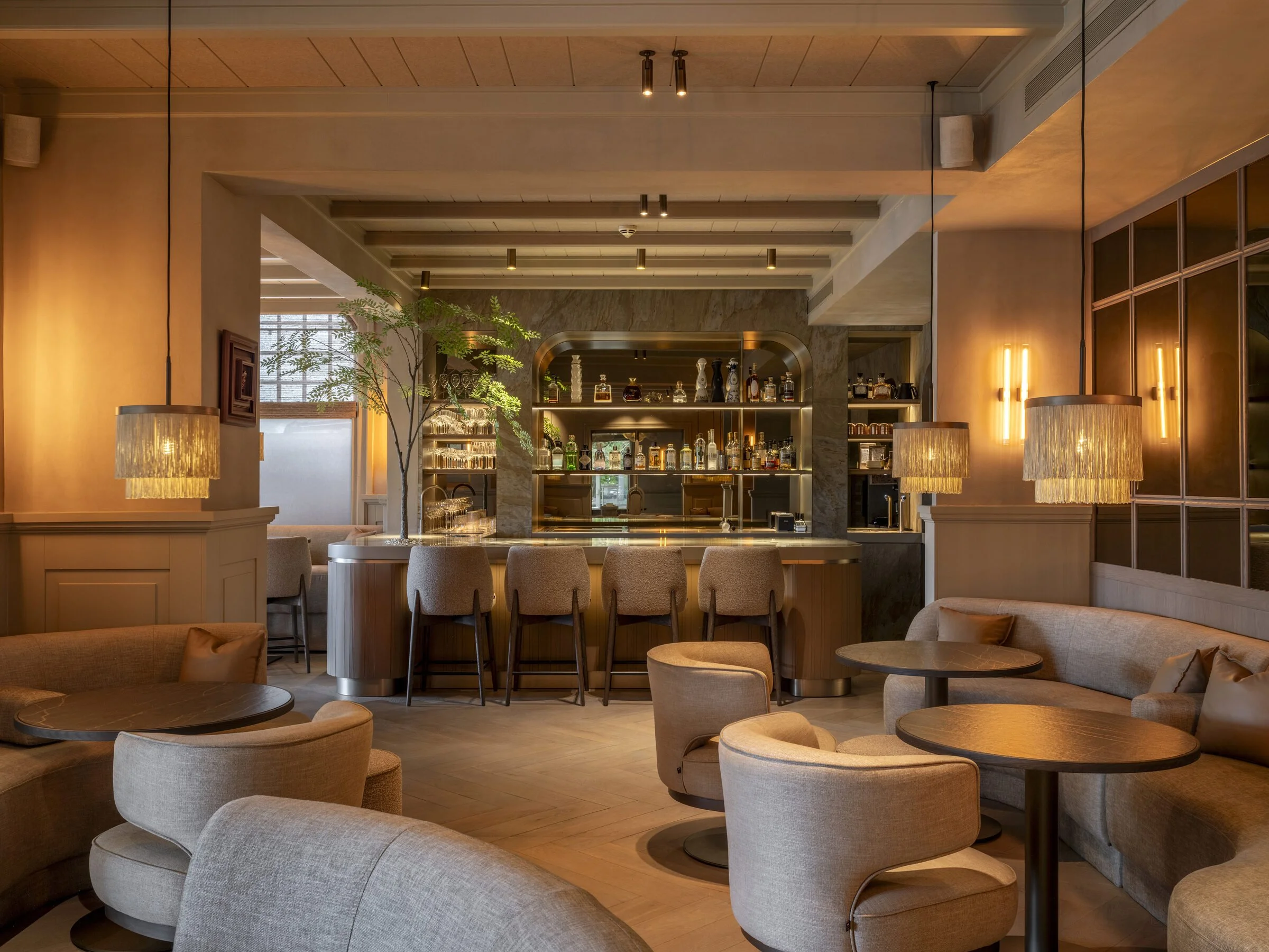 The bar and lounge of Lumé with the bespoke cocktail bar in green marble