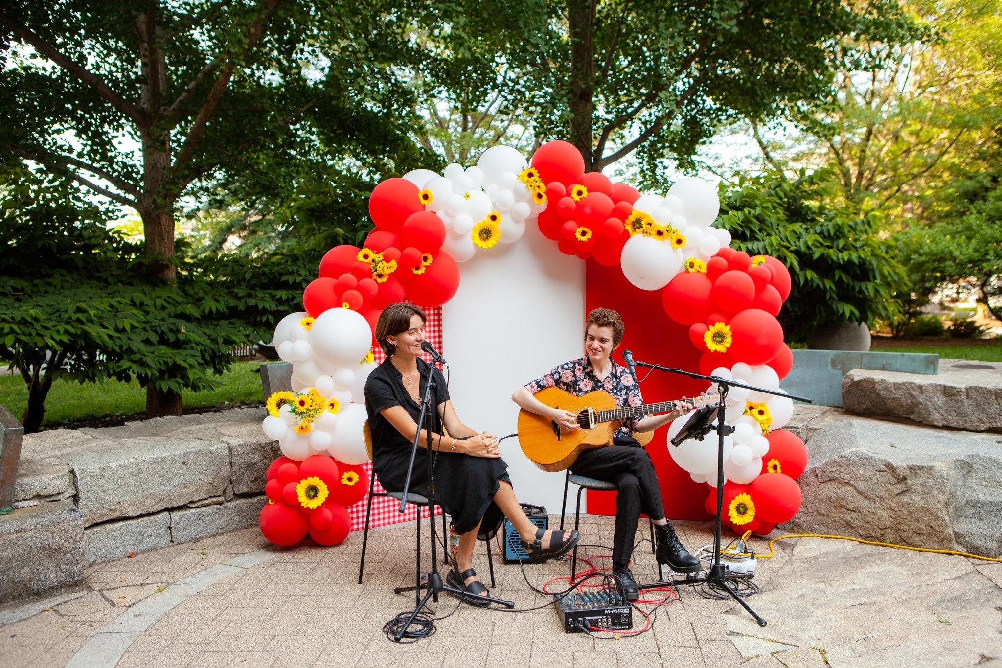 Throwback to this absolute vibe. ☀️

Acoustic guitar and vocalist duo (Talia &amp; Maren) in the Seaport last June. Happy Hour. Warm weather. A stunning red and white balloon display. And two musicians smiling like they're exactly where they're suppo