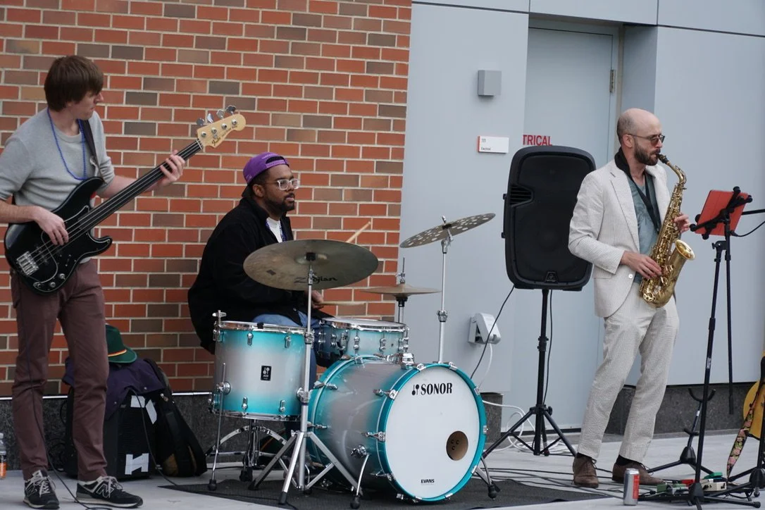 Live trio performing at a fall event at CambridgePark Drive.