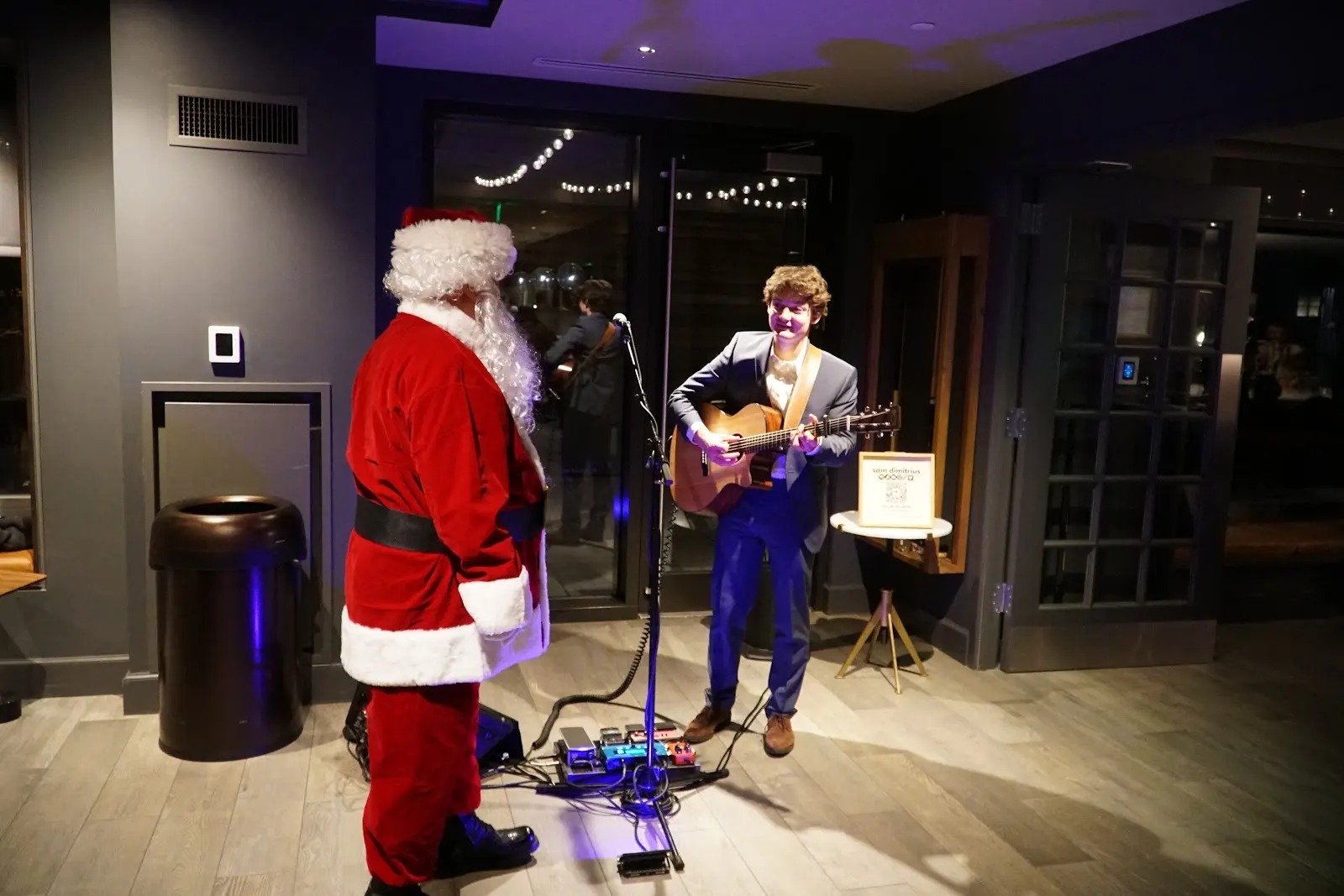 Guitarist performing beside Santa at The Harlo’s resident holiday celebration