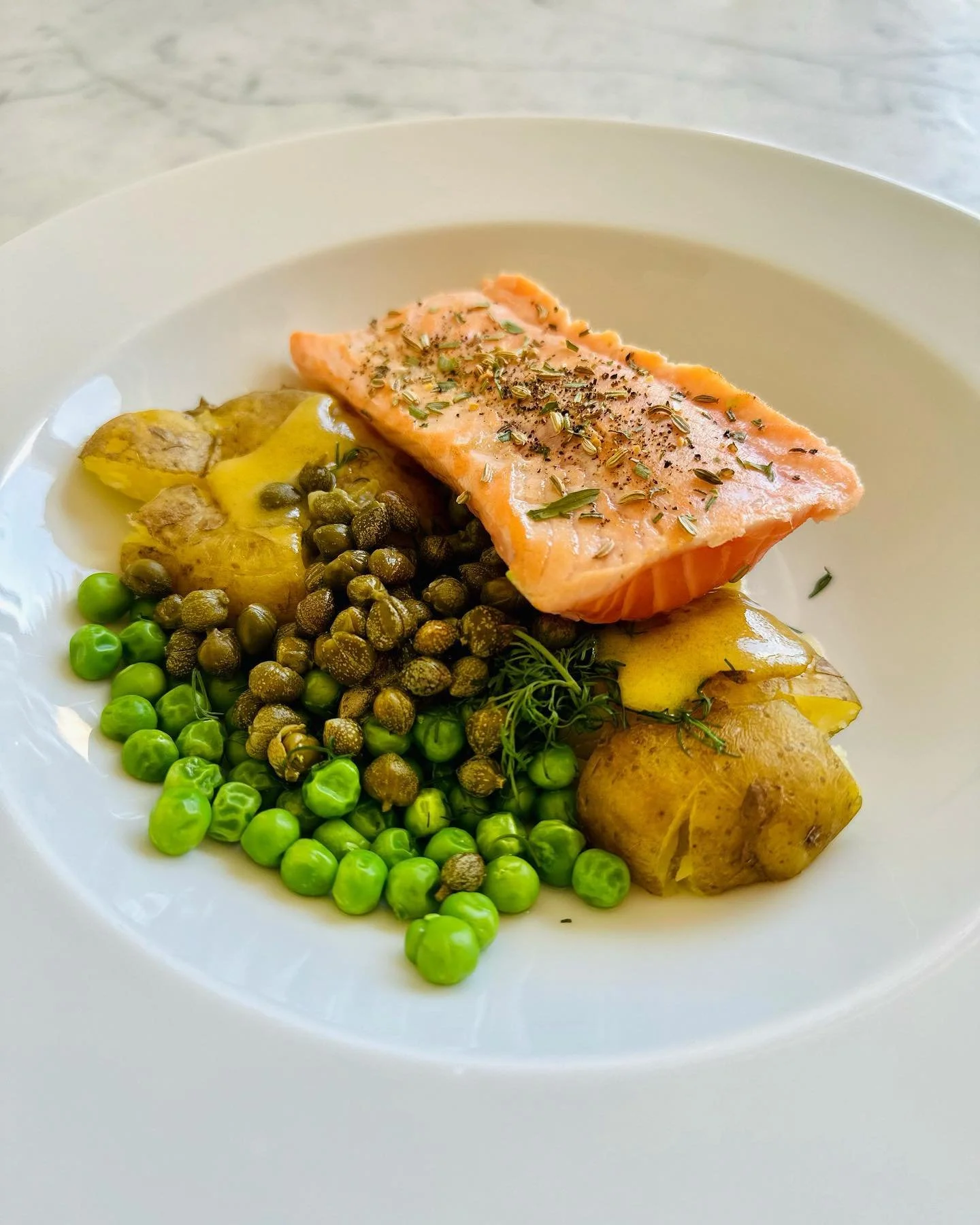 Sashimi Salmon with vinaigrette, capers, dill &amp; green pea potato salad 
Ingredients:
- 4 medium-sized potatoes or 8 small new potatoes
- 1 cup peas
- 1 tablespoon Dijon mustard
- 2 tablespoons mirin sauce
- 2 tablespoons olive oil
- 1 tablespoon 