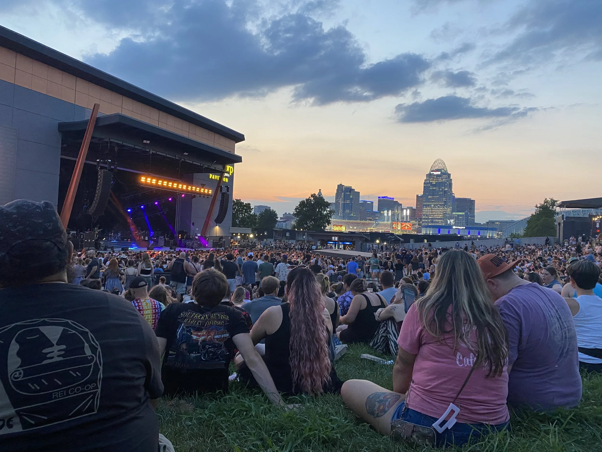 People sitting on lawn at MegaCorp Pavilion