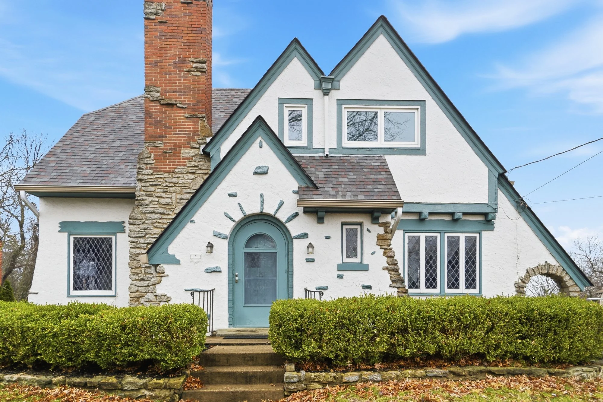 Green and cream Tudor home with leaded glass windows in Paddock Hills neighborhood for sale by top Cincinnati real estate agent Leah Joos.