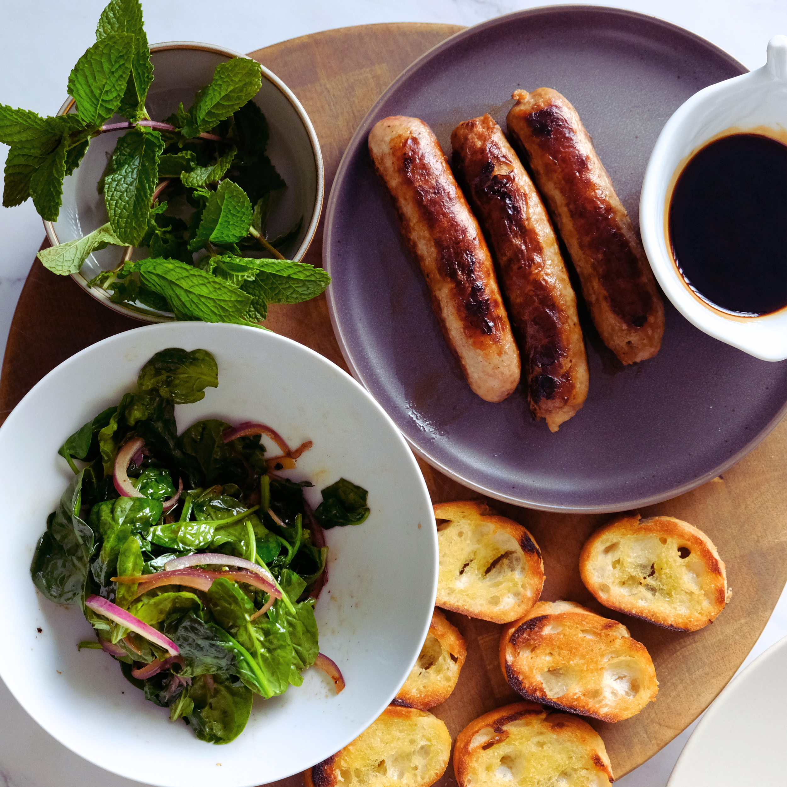 cooked sausage, soinach croutons and balsamic glaze.png
