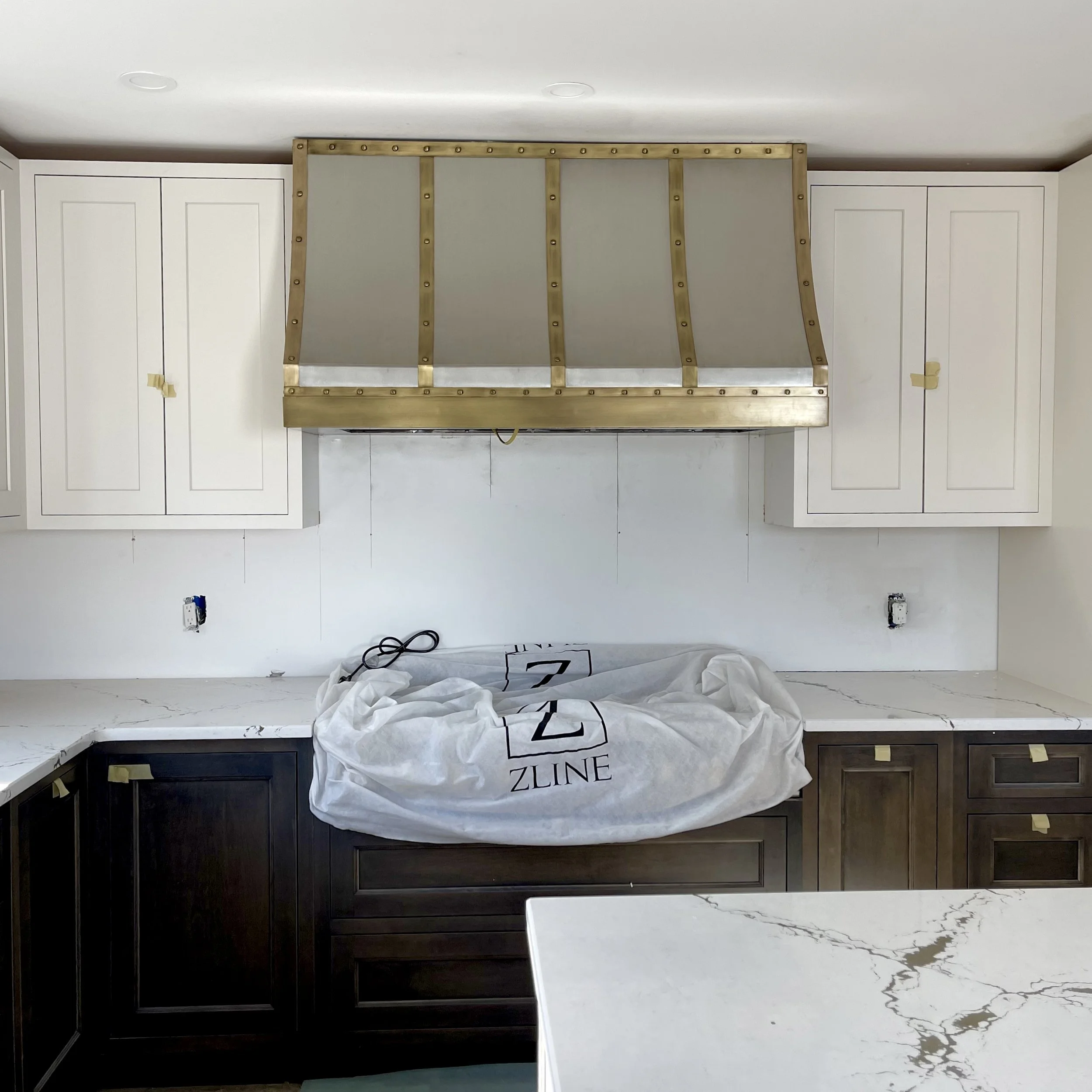 Custom Stainless Steel Range Hood with Antique Brass Straps — Monarch
