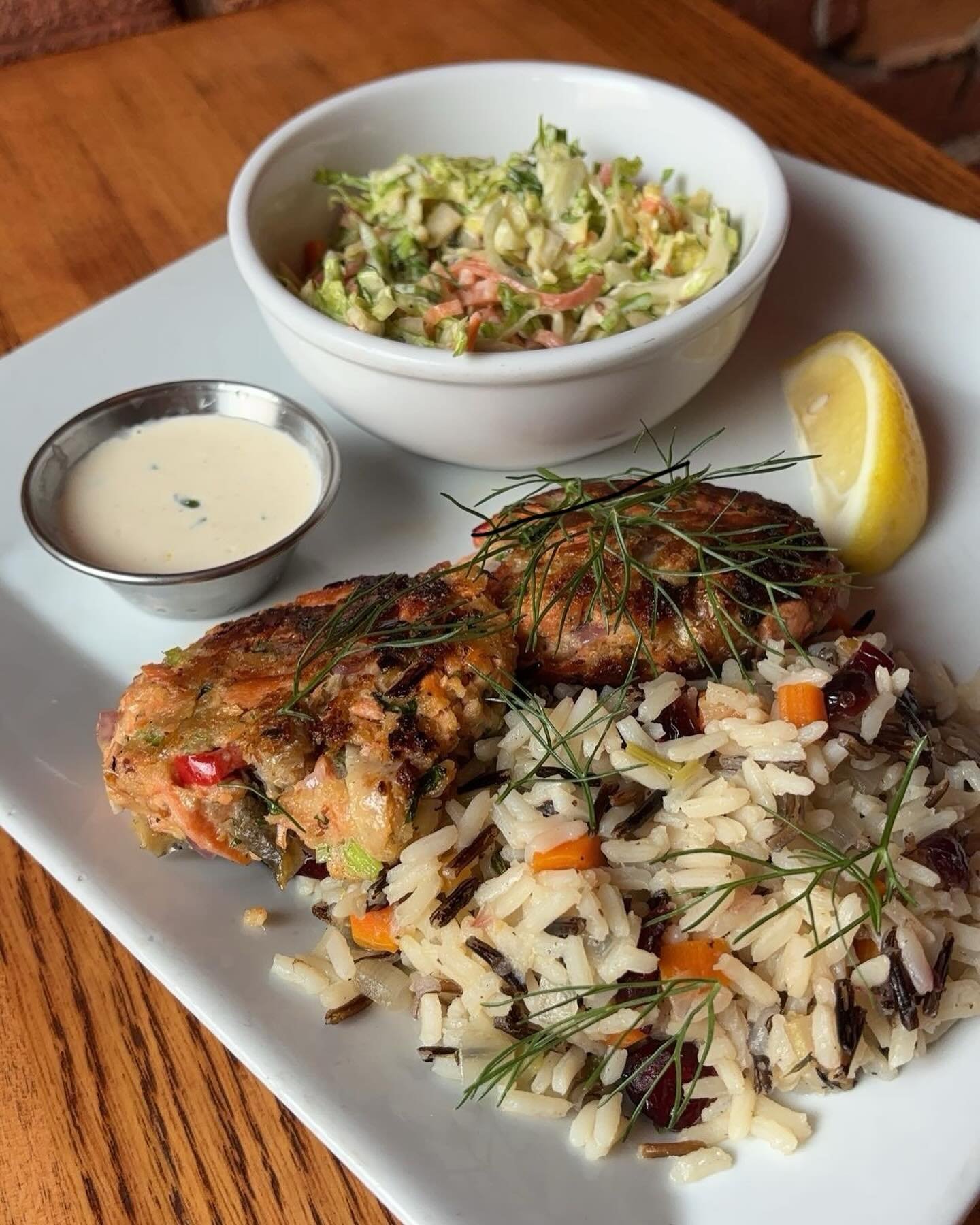 This weekend&rsquo;s special! Salmon croquettes with a lemon yogurt sauce, wild rice pilaf, and brussels sprout slaw - stop in to try it before it&rsquo;s gone 🍋