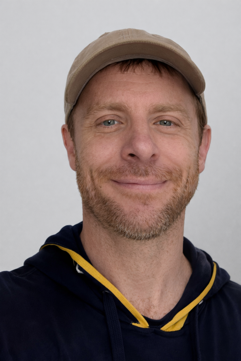 A blurred interior space with large windows and sunlight, overlaid with text stating 'Photo coming soon!' and the logo and name of Harmony Yoga Studios.