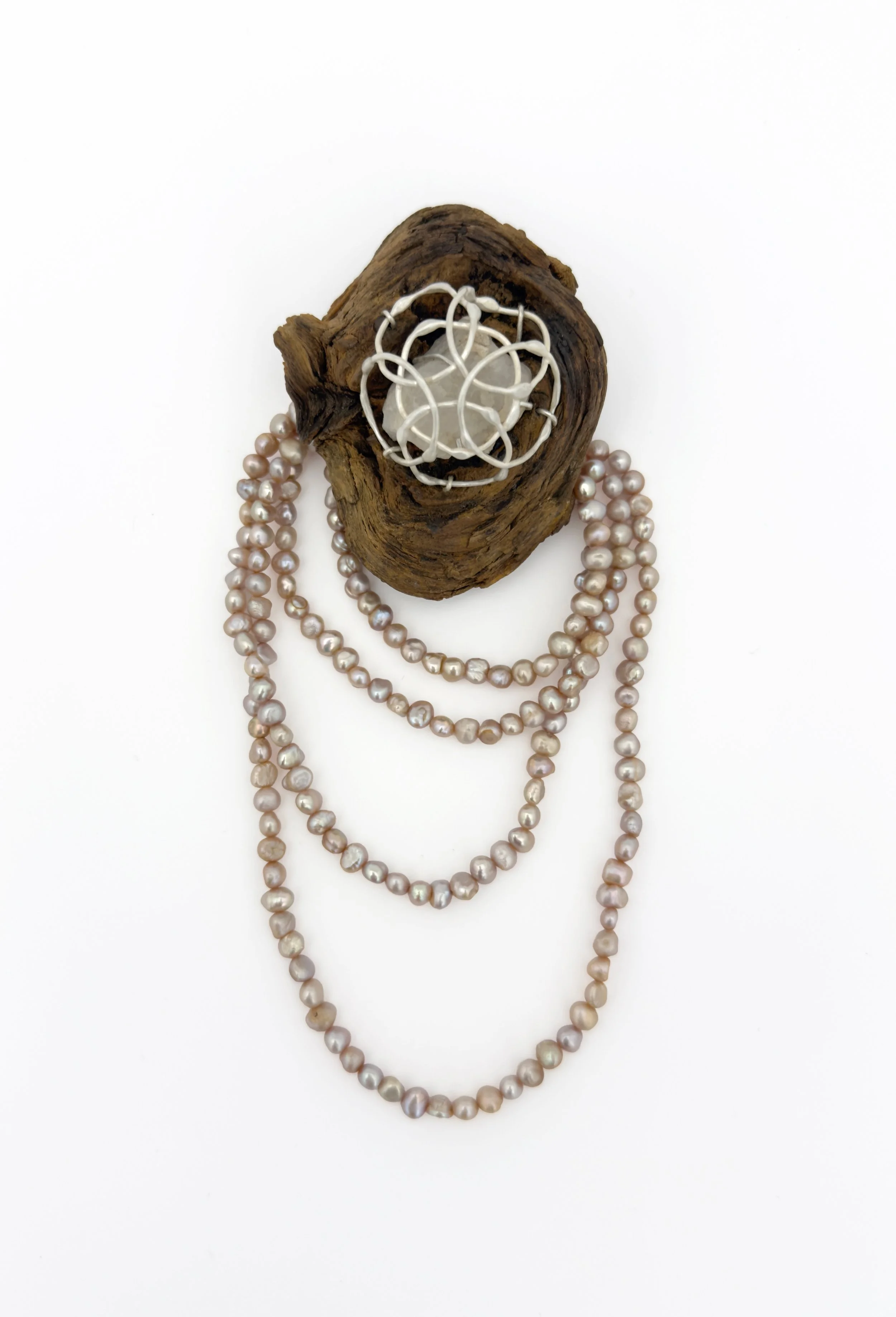 breathe 24 (brooch)
recycled silver, found wood, found quartz, repurposed natural pearls
6 1/2" x 2 1/2" x 1 1/2"
2026
