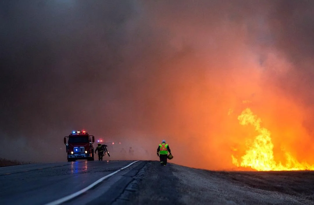 A firefighters walks into the smoke to help other crew members. Multiple stations were called to contain the brush fire. West of Thompson, ND on Tuesday, March 29, 2016. (Joshua Komer/Grand Forks Herald)