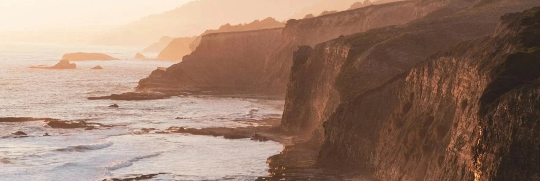 Sunset over ocean cliffs along the coast