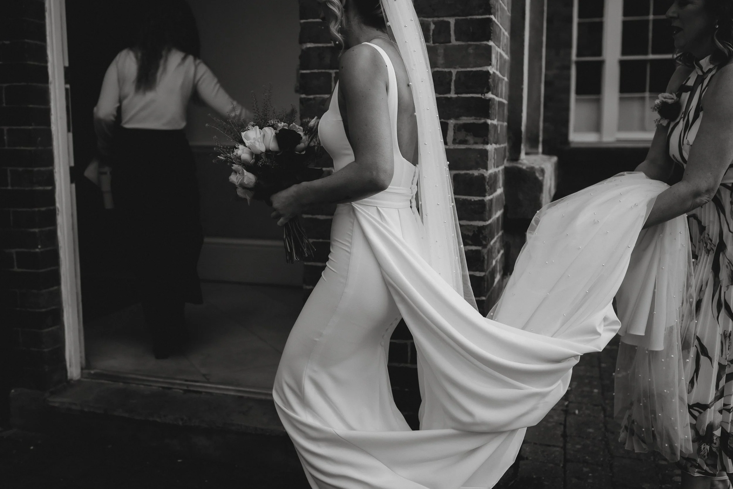 Bride leaving for her ceremony at Netley Hall during her winter wedding