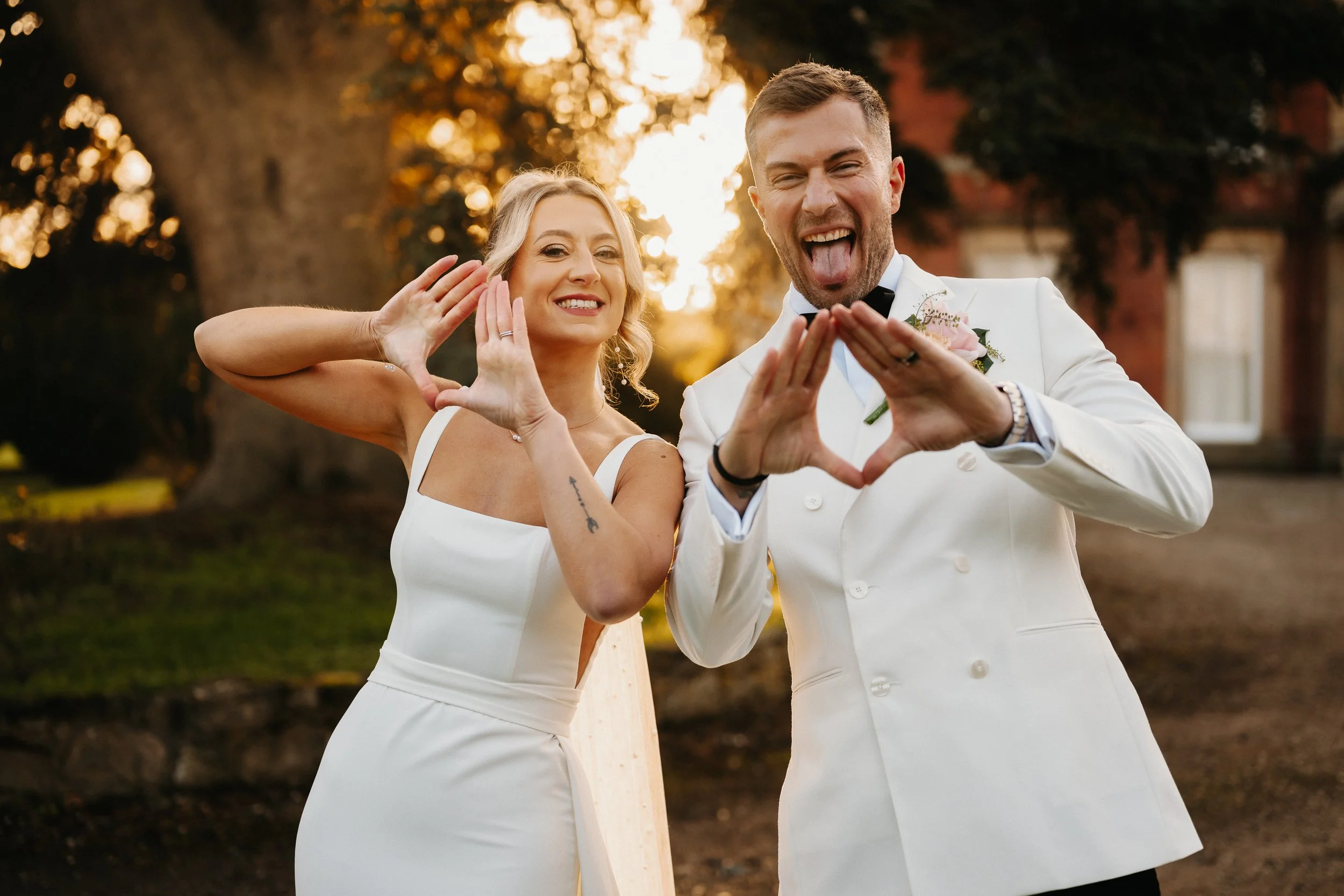 Bride and groom sharing relaxed, joyful portraits outside Netley Hall during their winter wedding, smiling naturally together.