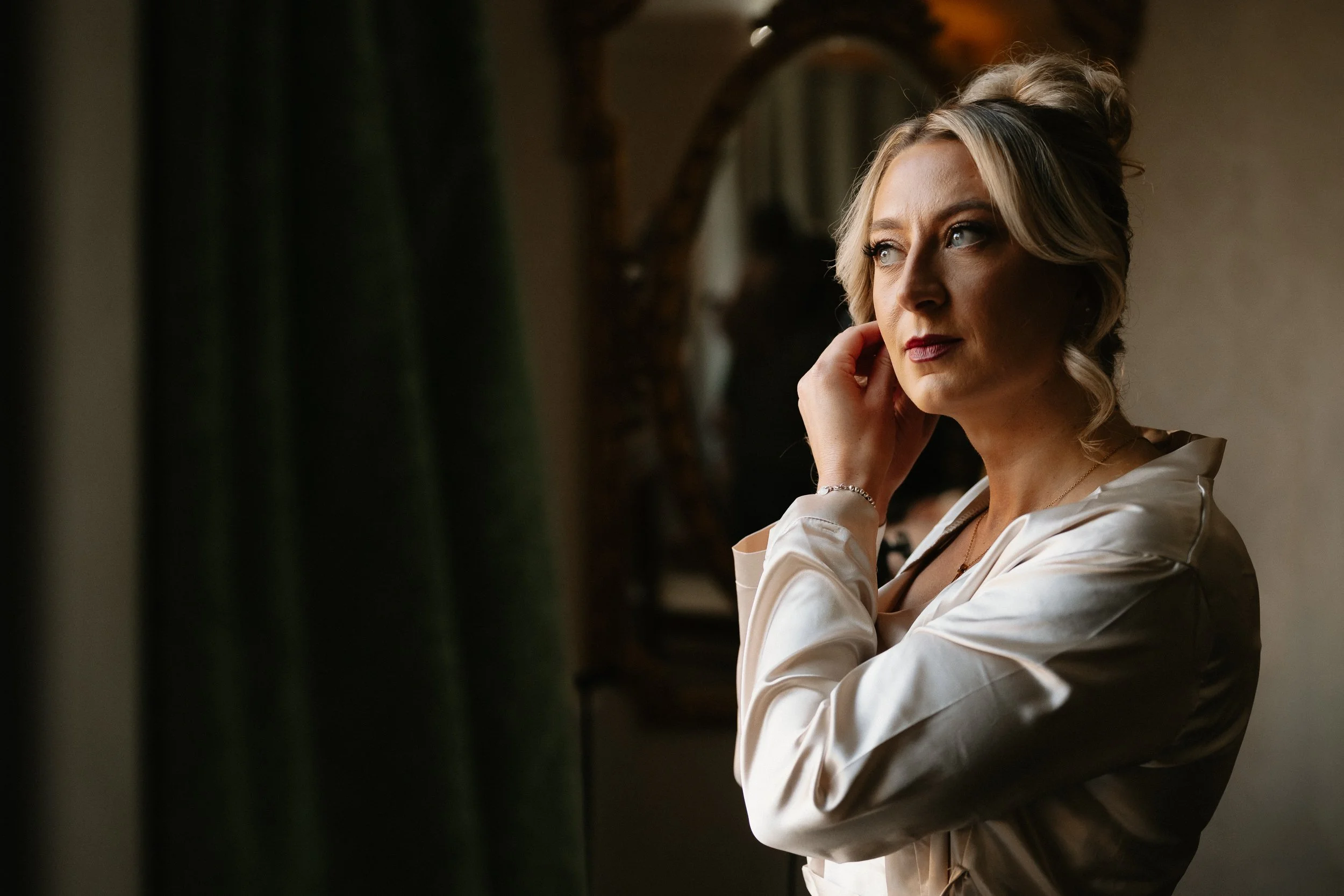 Wedding morning at Netley Hall, the bride adding the finishing details