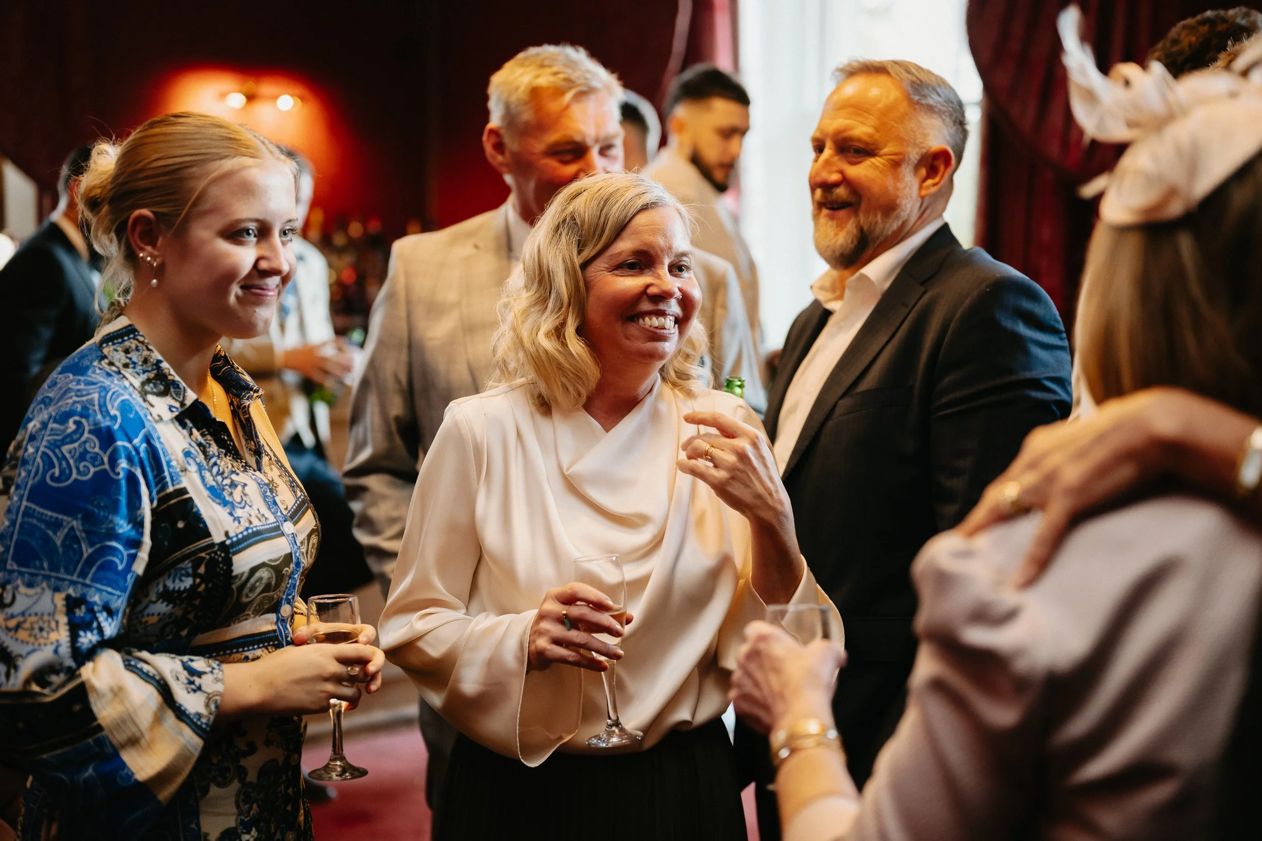 Wedding guests enjoying canapés during the winter drinks reception at Netley Hall, mingling and chatting after the ceremony.