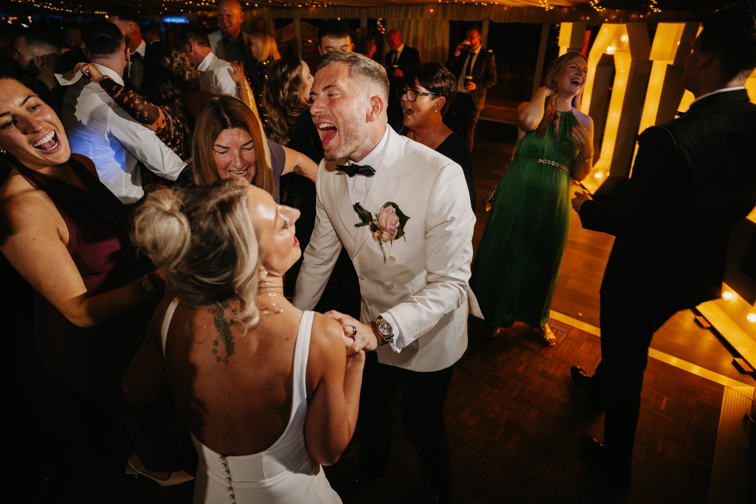 Packed dance floor during the winter wedding reception at Netley Hall, with guests dancing and celebrating late into the evening.