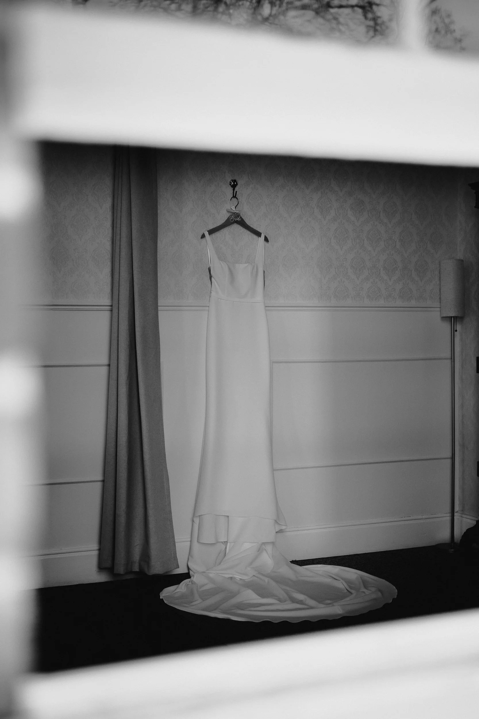 Bride’s wedding dress hanging up at Netley Hall winter wedding