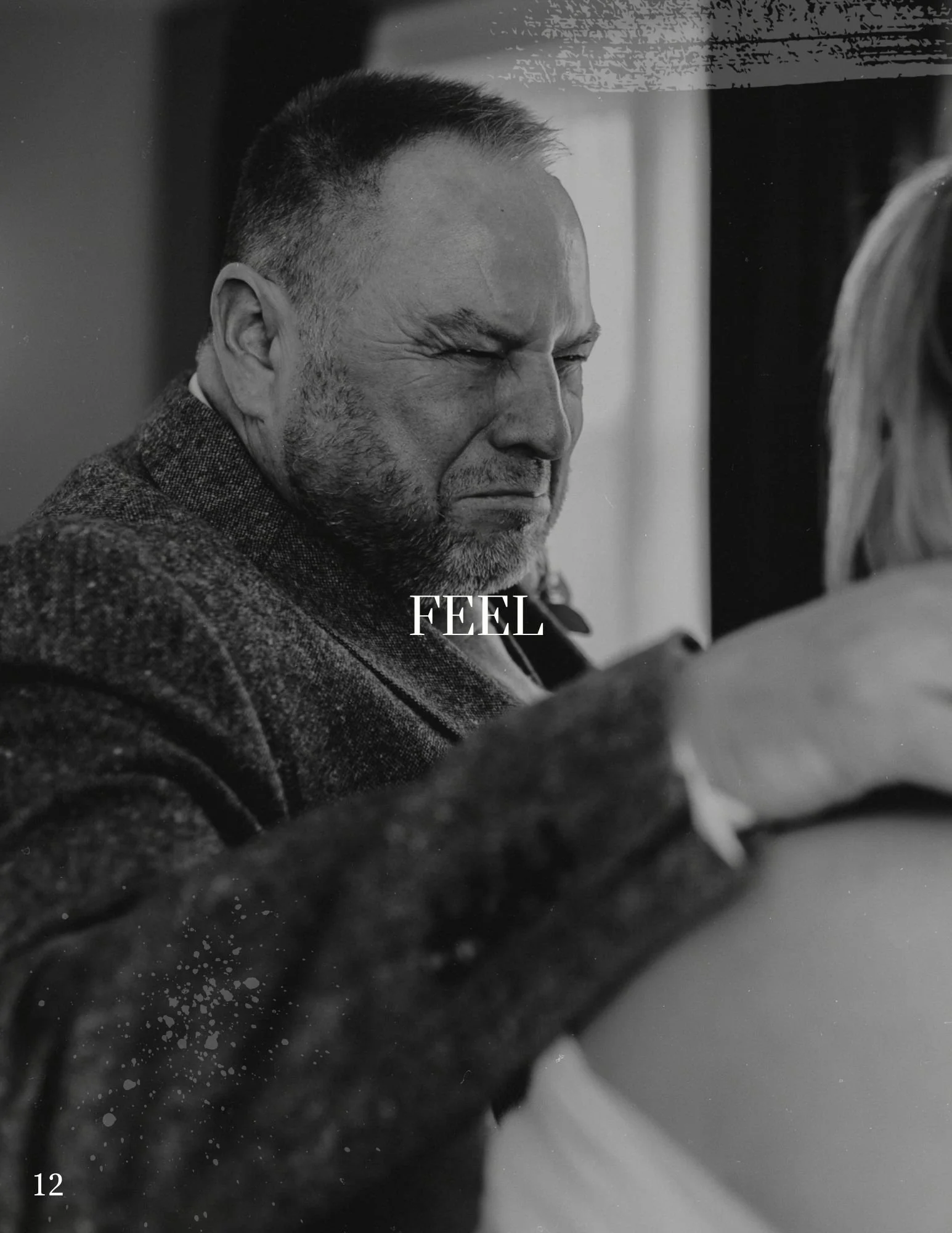 A black and white photo of a man with a beard and short hair, showing an expression of pain or distress, with the word 'FEEL' in the center.