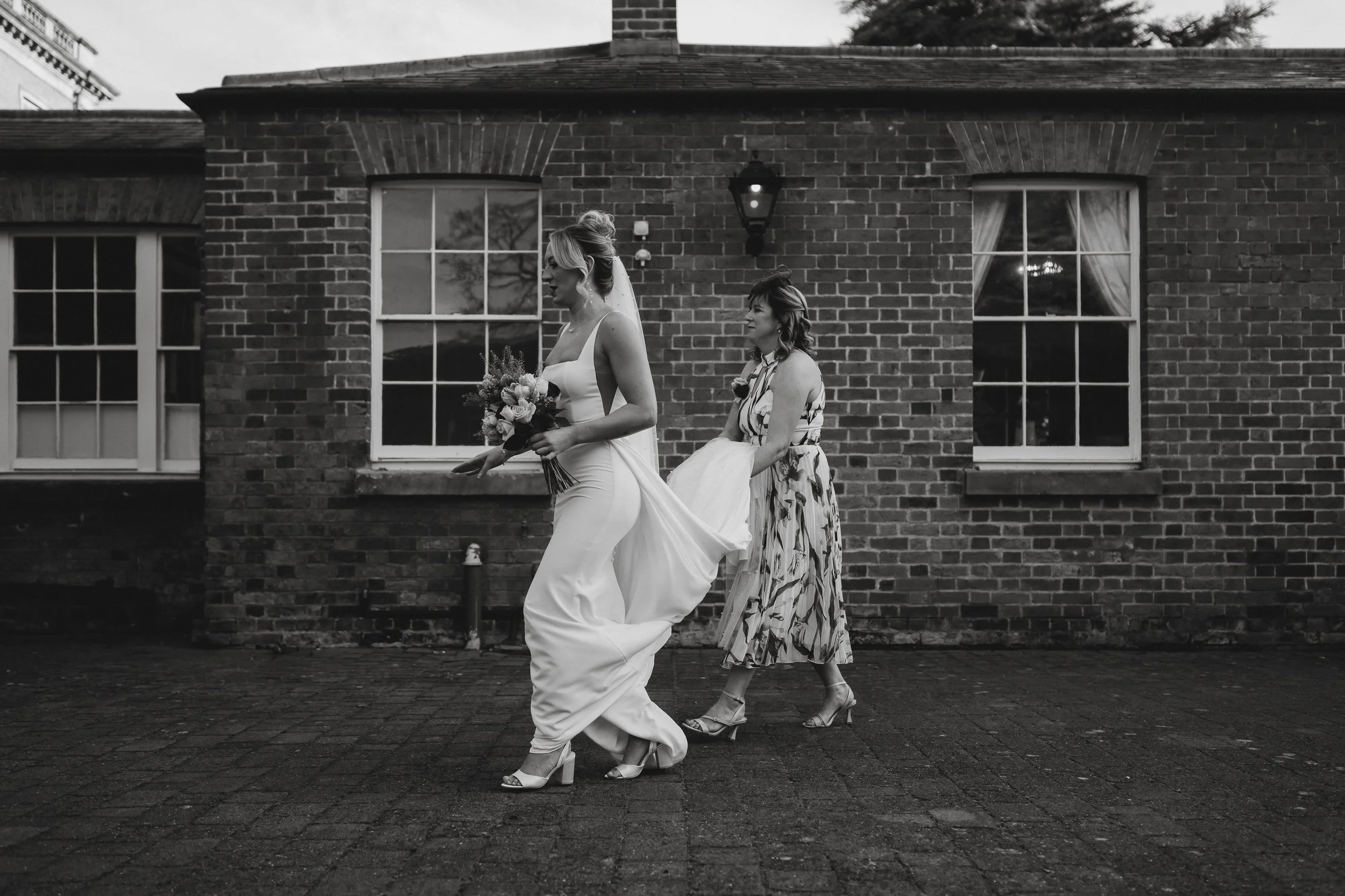 Bride leaving for her ceremony at Netley Hall during her winter wedding