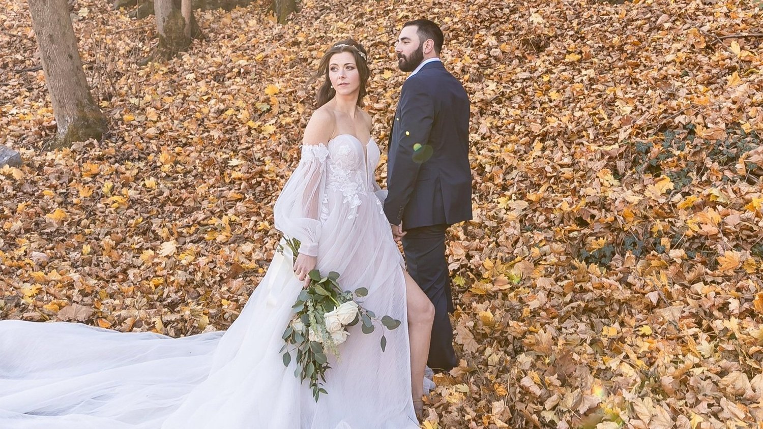 Bride and groom in autumn leaves at The Red Mill Museum