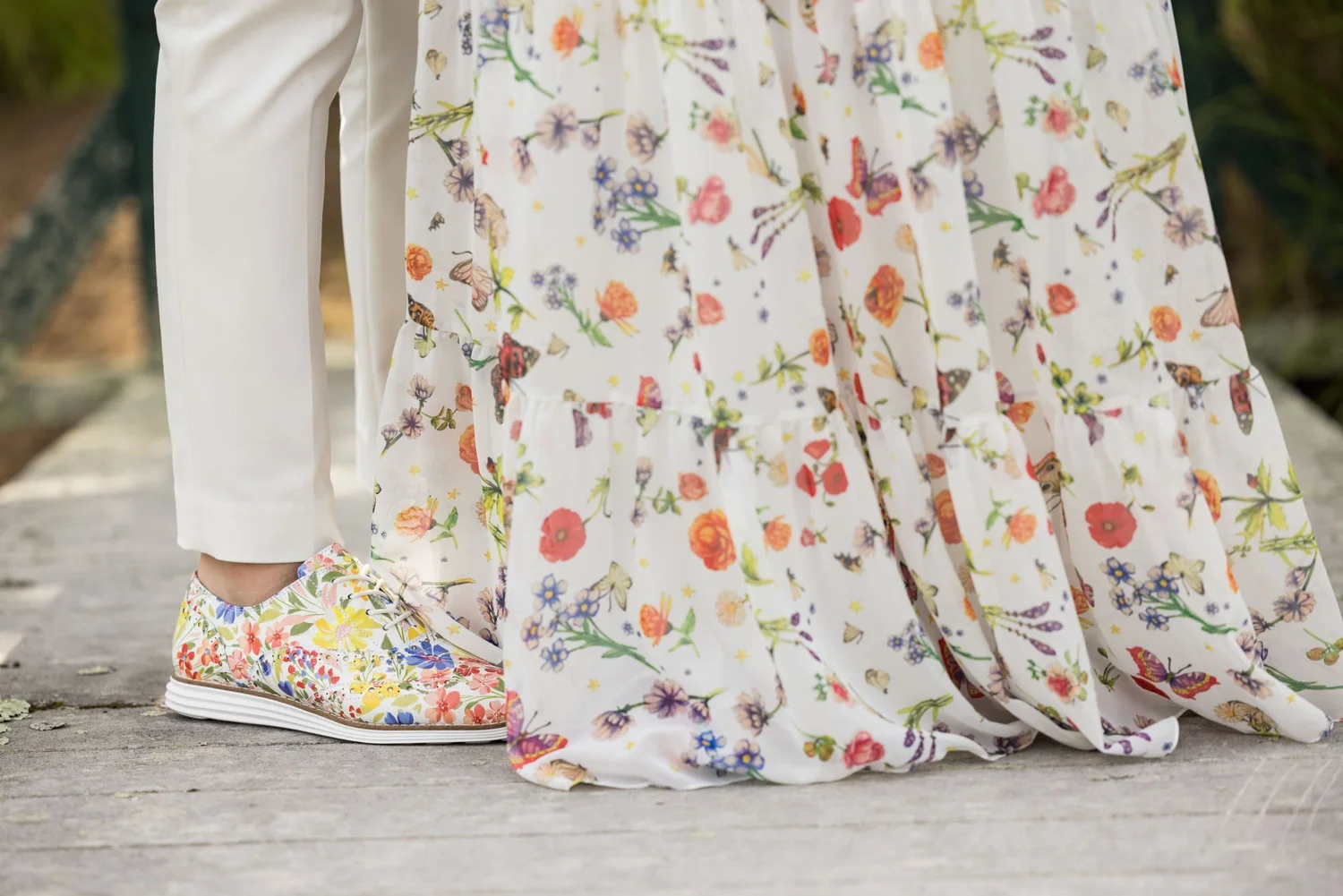 Close-up of a couple's floral wedding outfits
