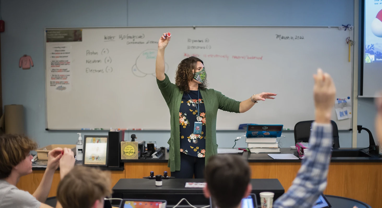 Image of a teacher wearing a face mask for the article: How Schools Survived Two Years of COVID-19