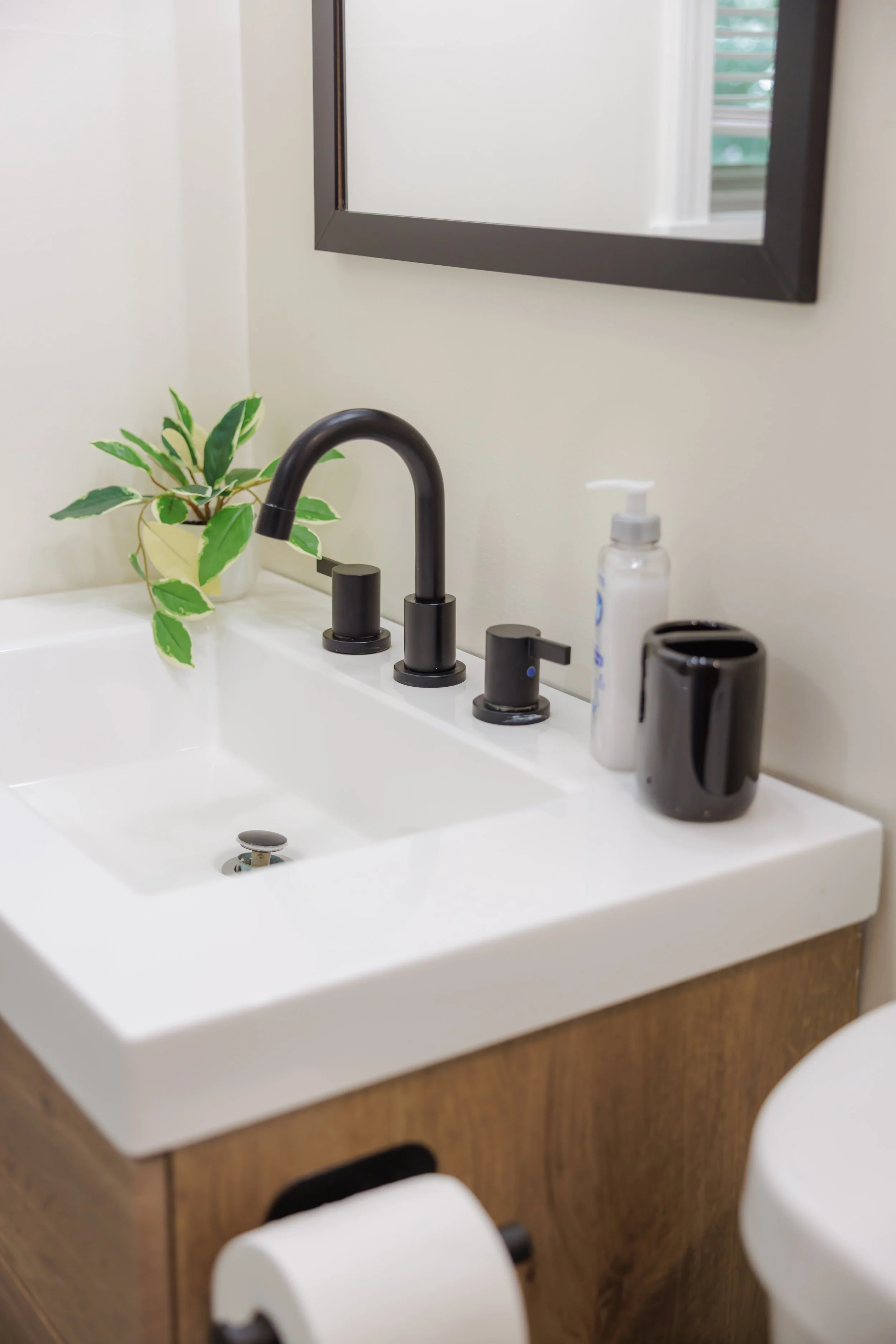 Minimal finishes and natural textures create a bathroom that feels refined yet approachable.